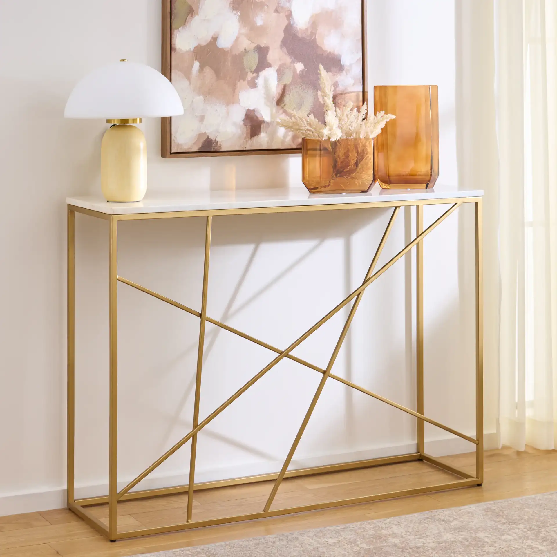 Lumen Marble Console Table in White Marble / Gold in a styled room