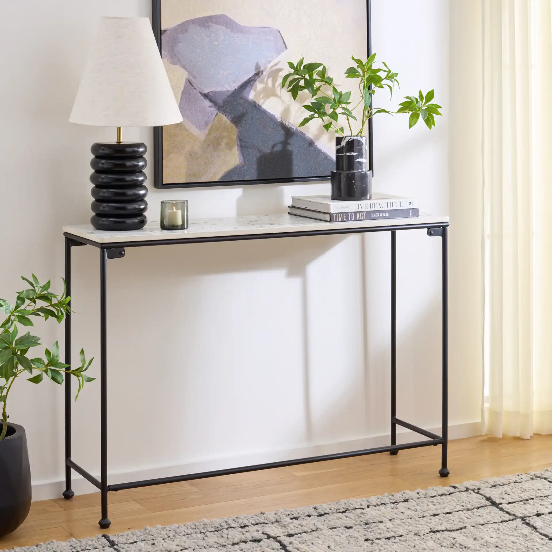 Amelina Ceramic Console Table in Gray / Black in a styled room