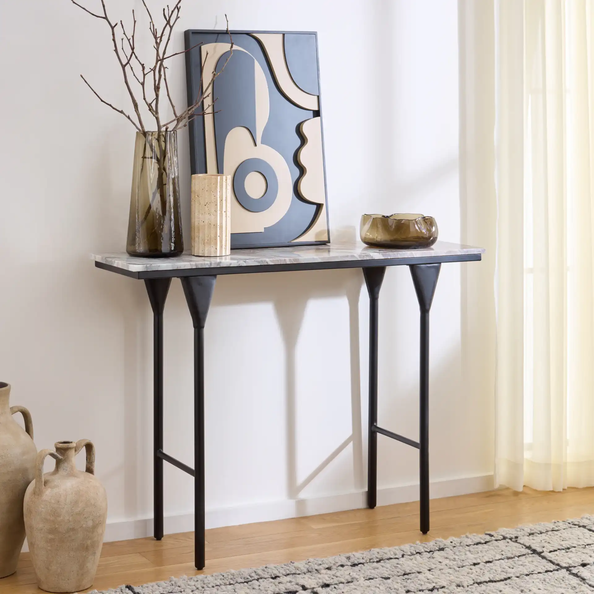 Frederick Marble Console Table in Brown Gray / Black in a styled room