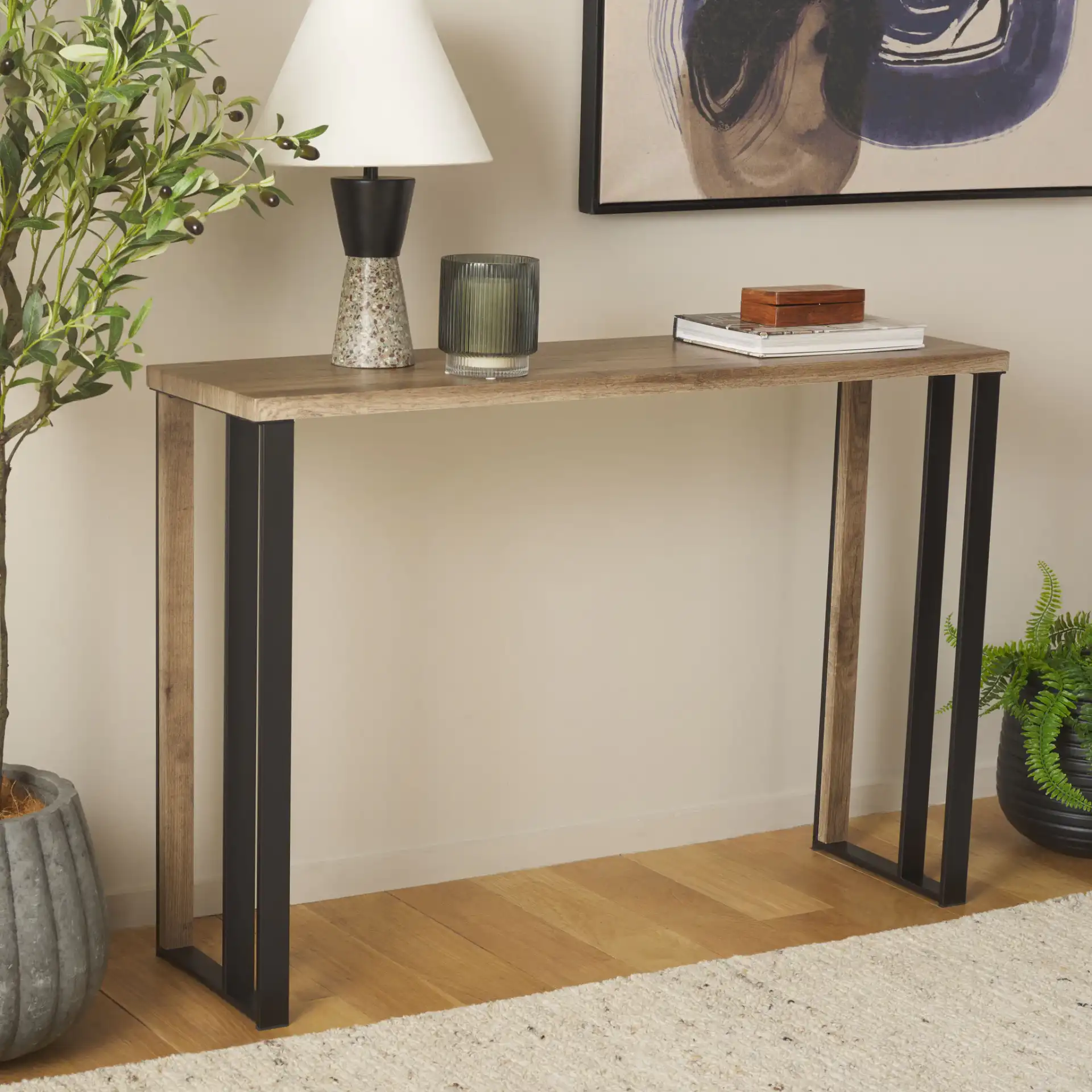 Carlino Console Table in Light Brown / Black in a styled room