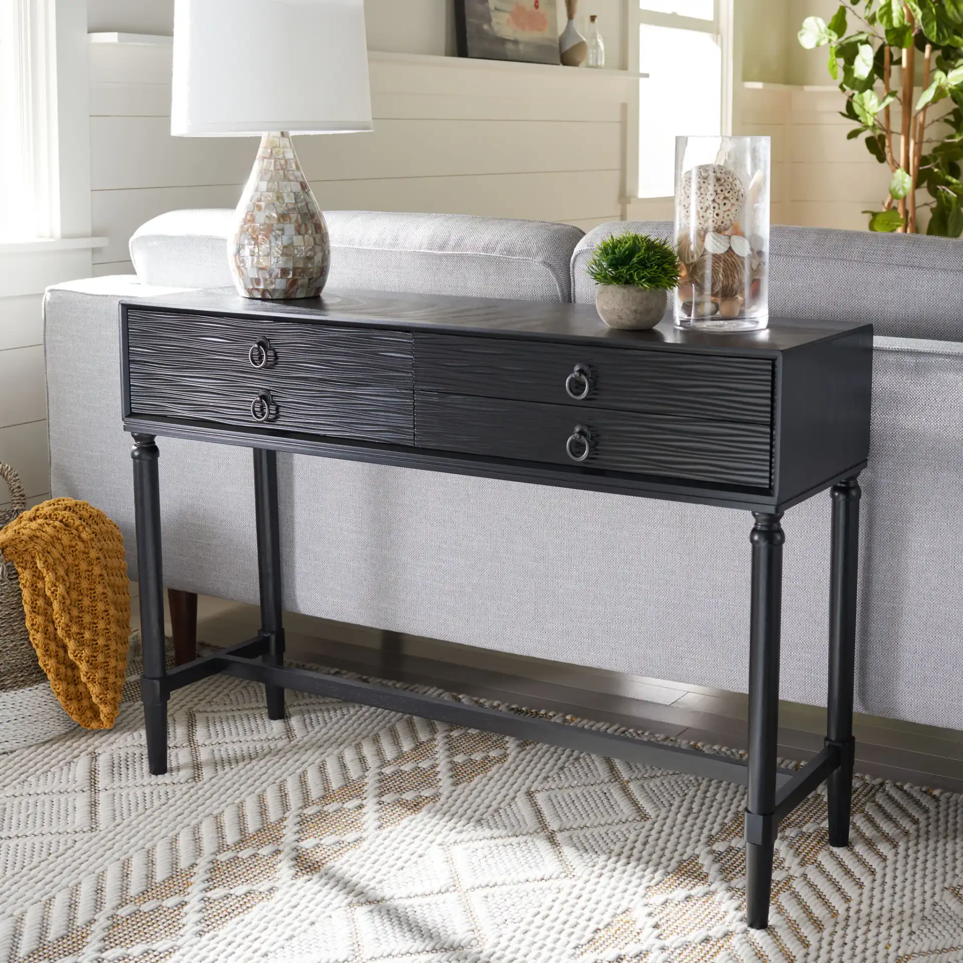 Aliyah Four-Drawer Console Table in Black in a styled room