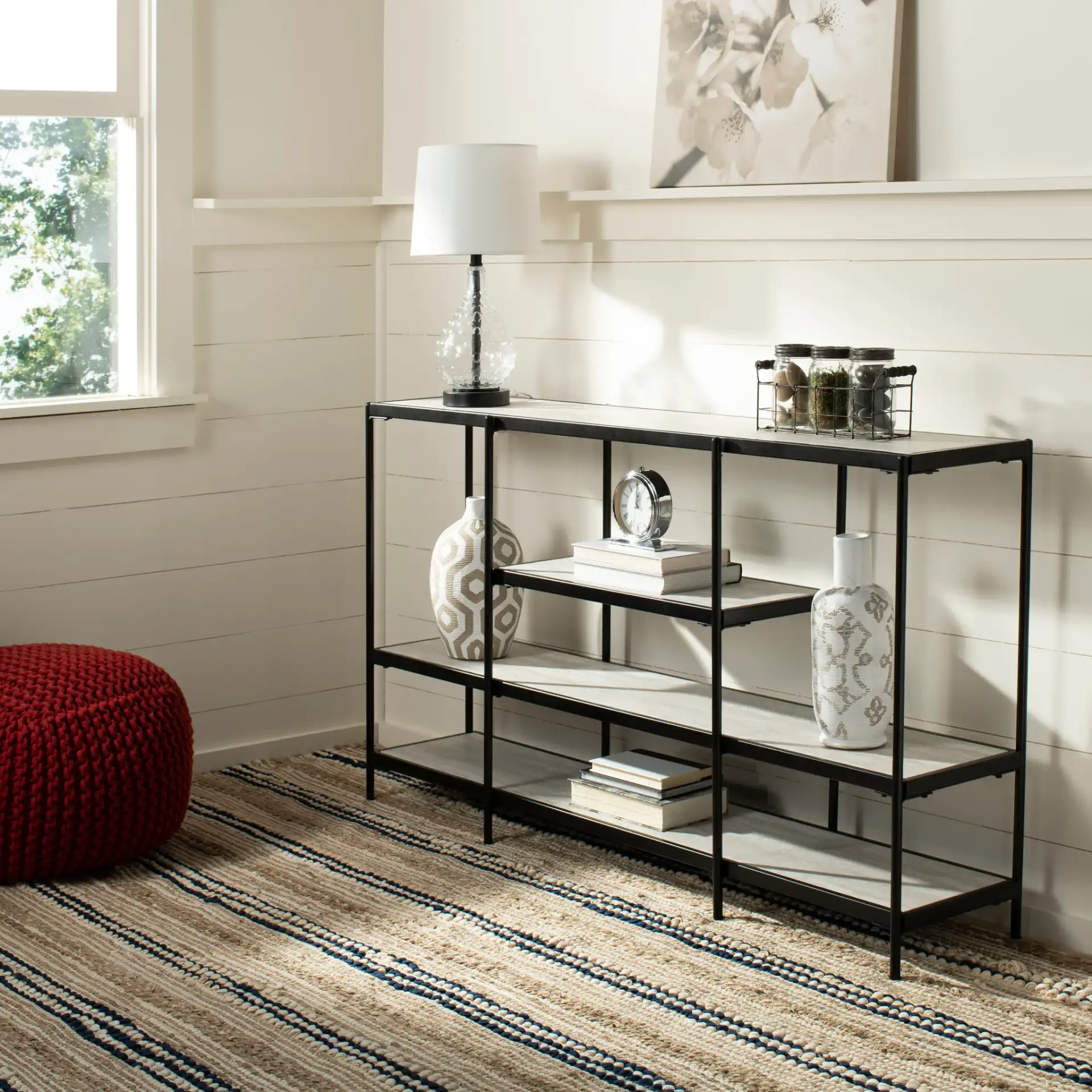 Petra Three-Tier Console Table in Beige / Matte Black in a styled room