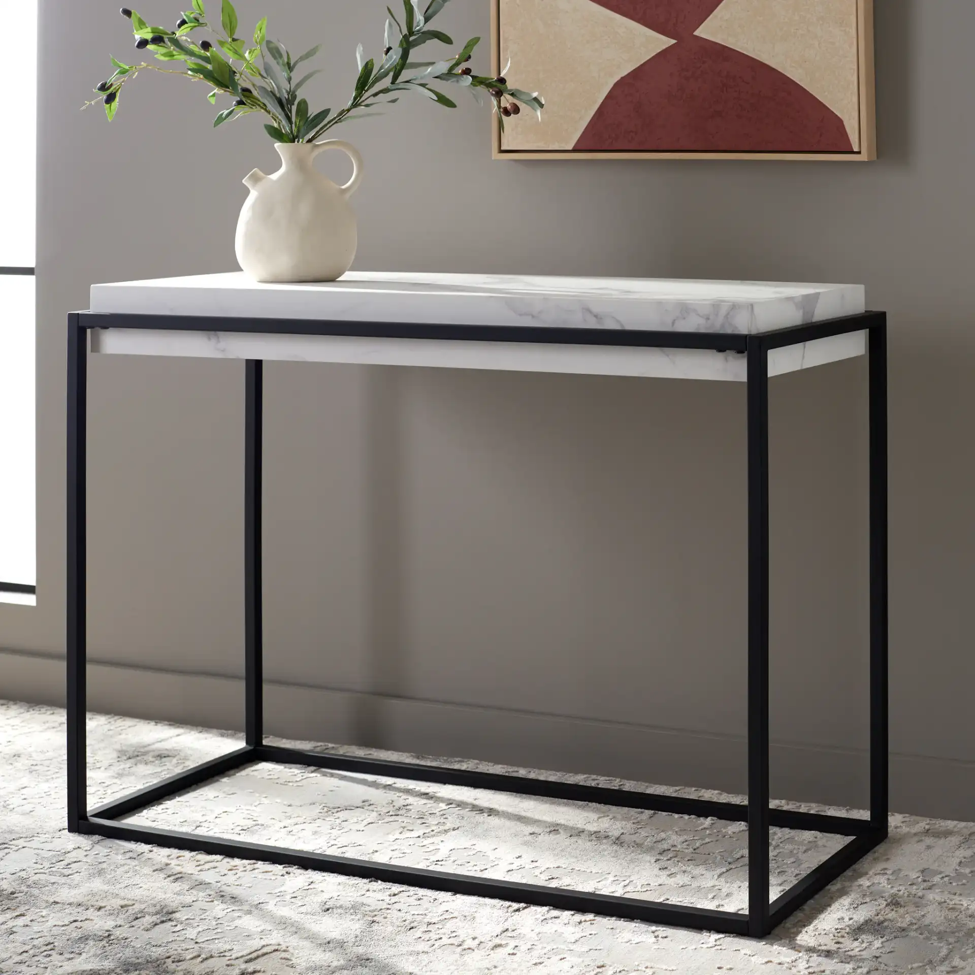 Edgefield Console Table in White Faux Marble / Black in a styled room