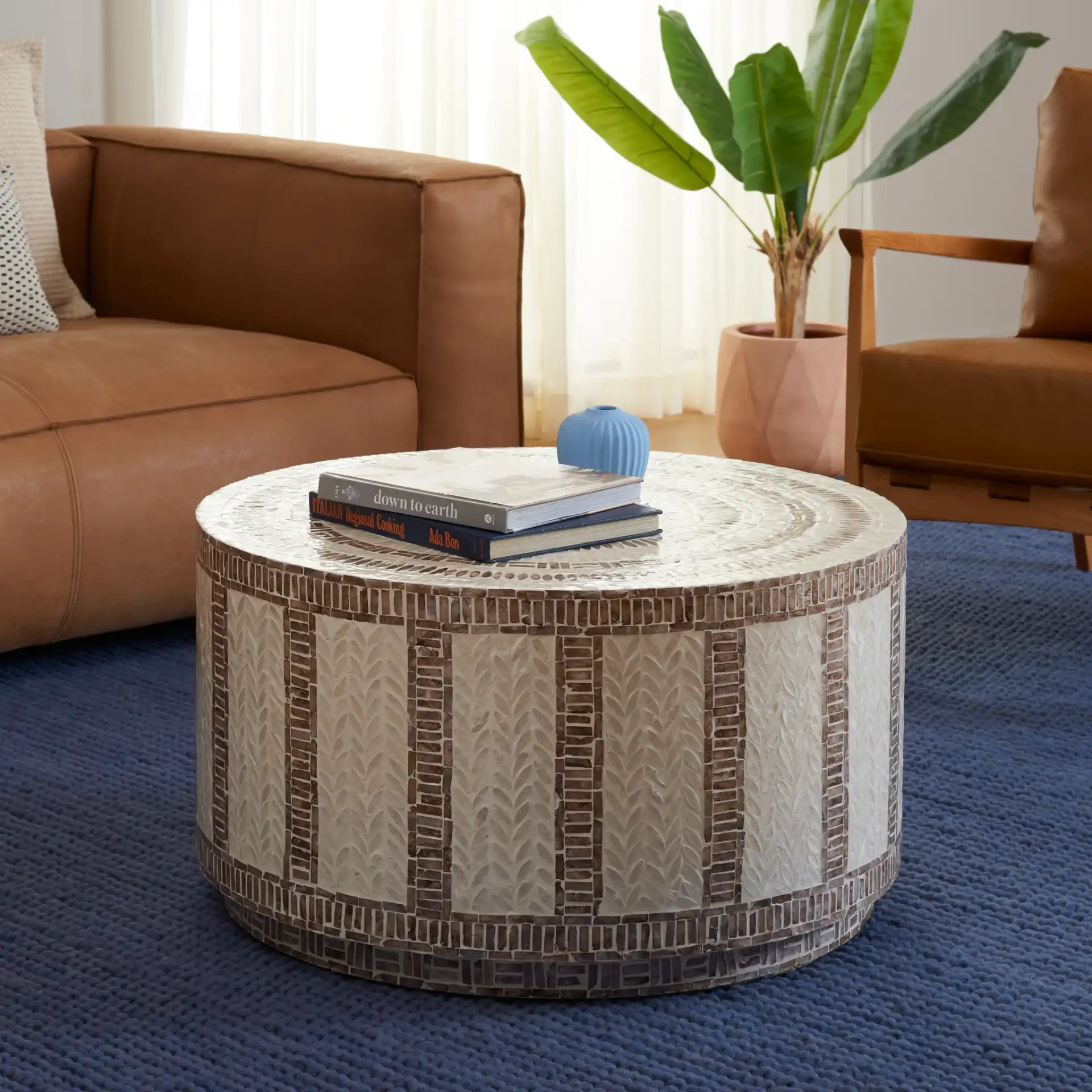 Keary Round Coffee Table in White / Gold in a styled room