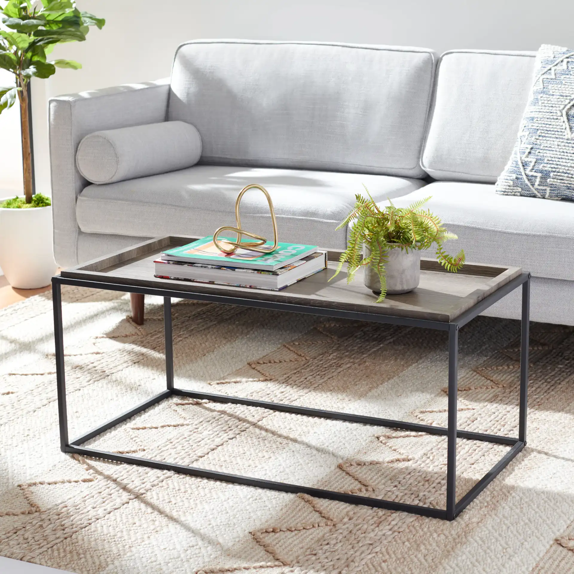 Andey Coffee Table in Brown / Black in a styled room