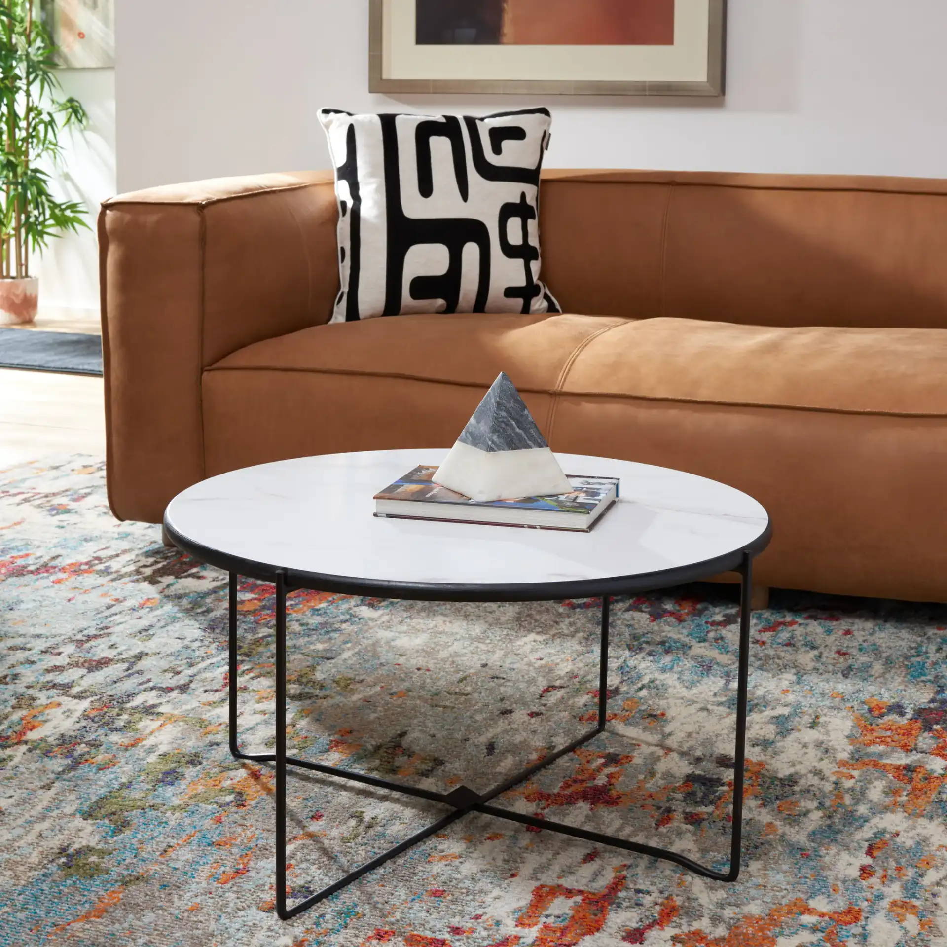 Wrena Round Coffee Table in White / Black in a styled room