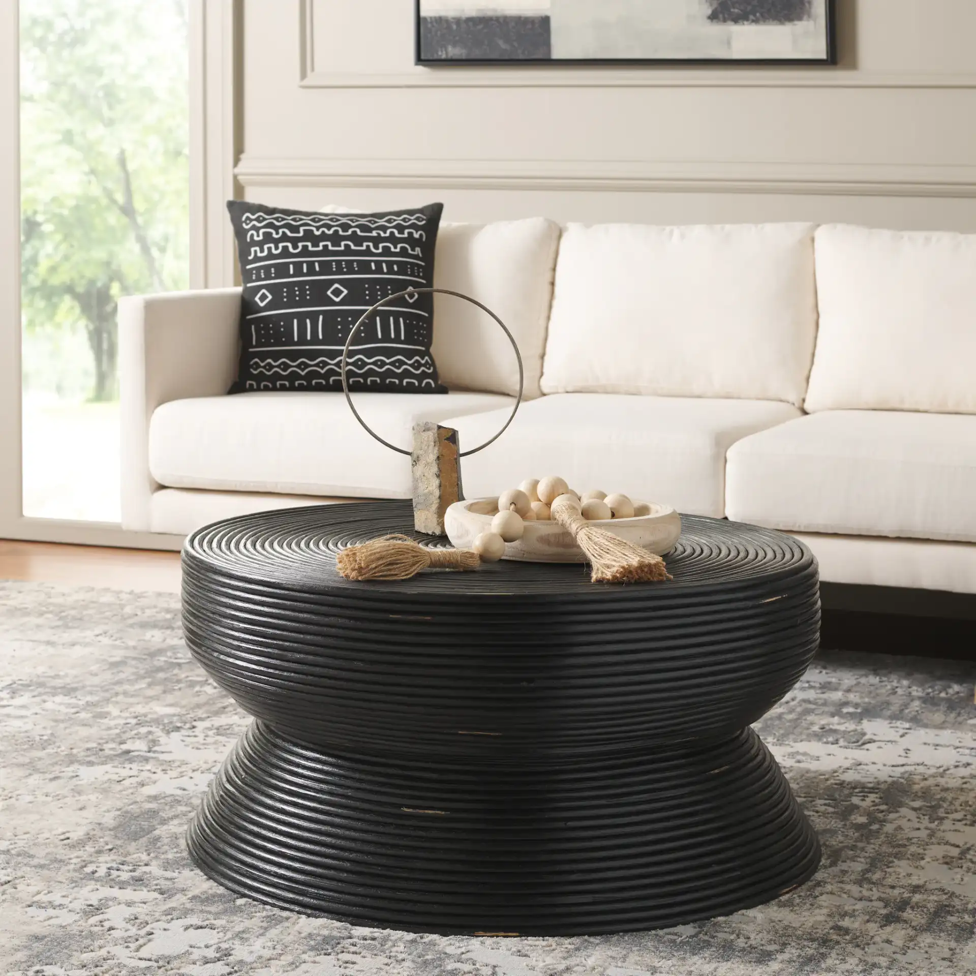 Heimdall Round Coffee Table in Distressed Black in a styled room