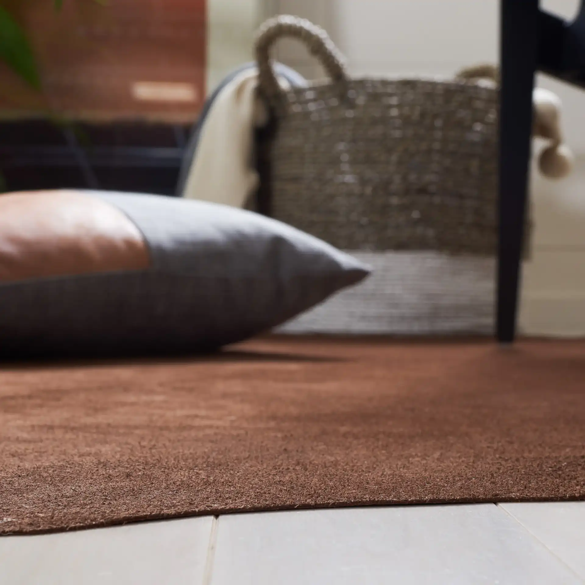 Suede Cowhide Shaped Rug in Light Brown in a styled room