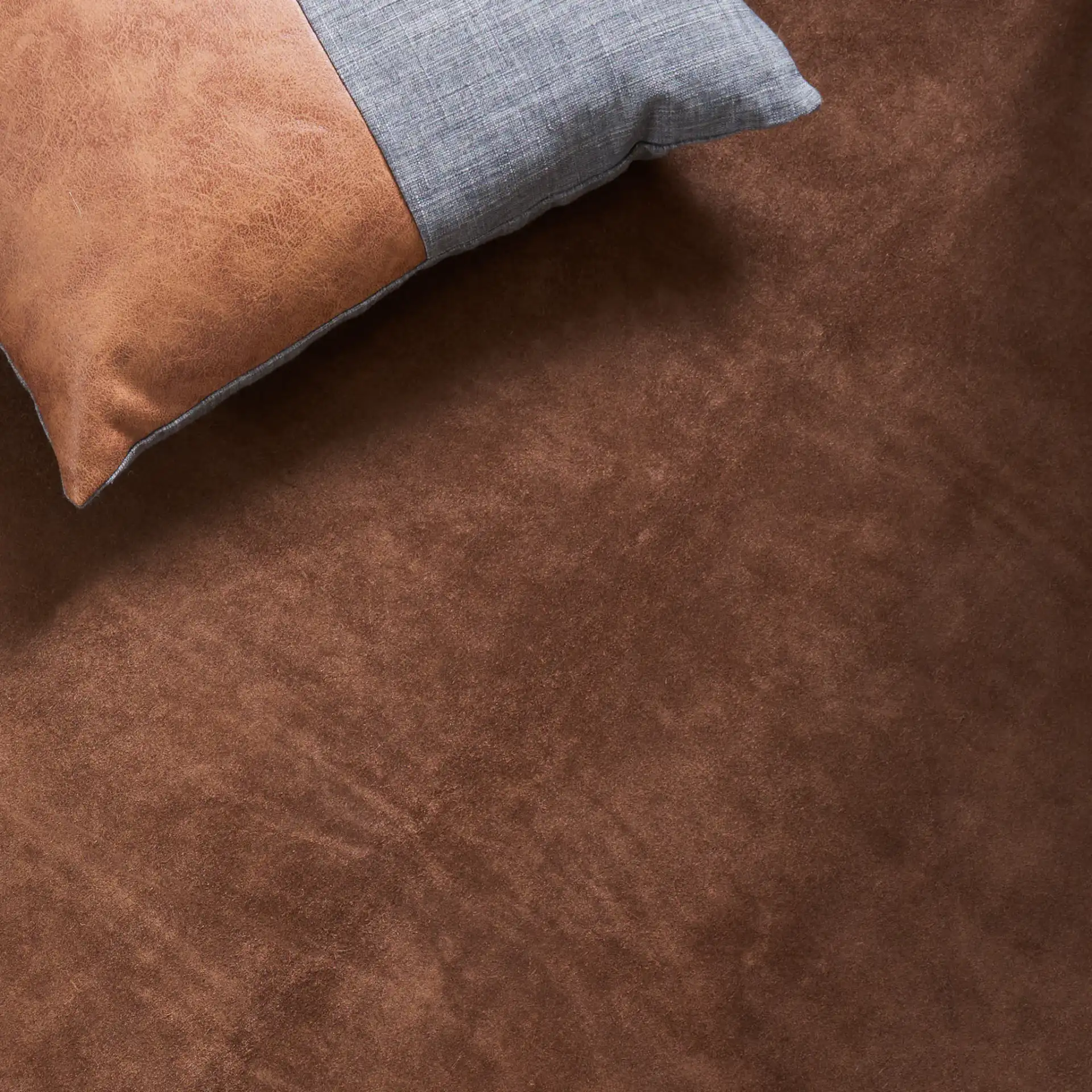 Suede Cowhide Shaped Rug in Light Brown in a styled room