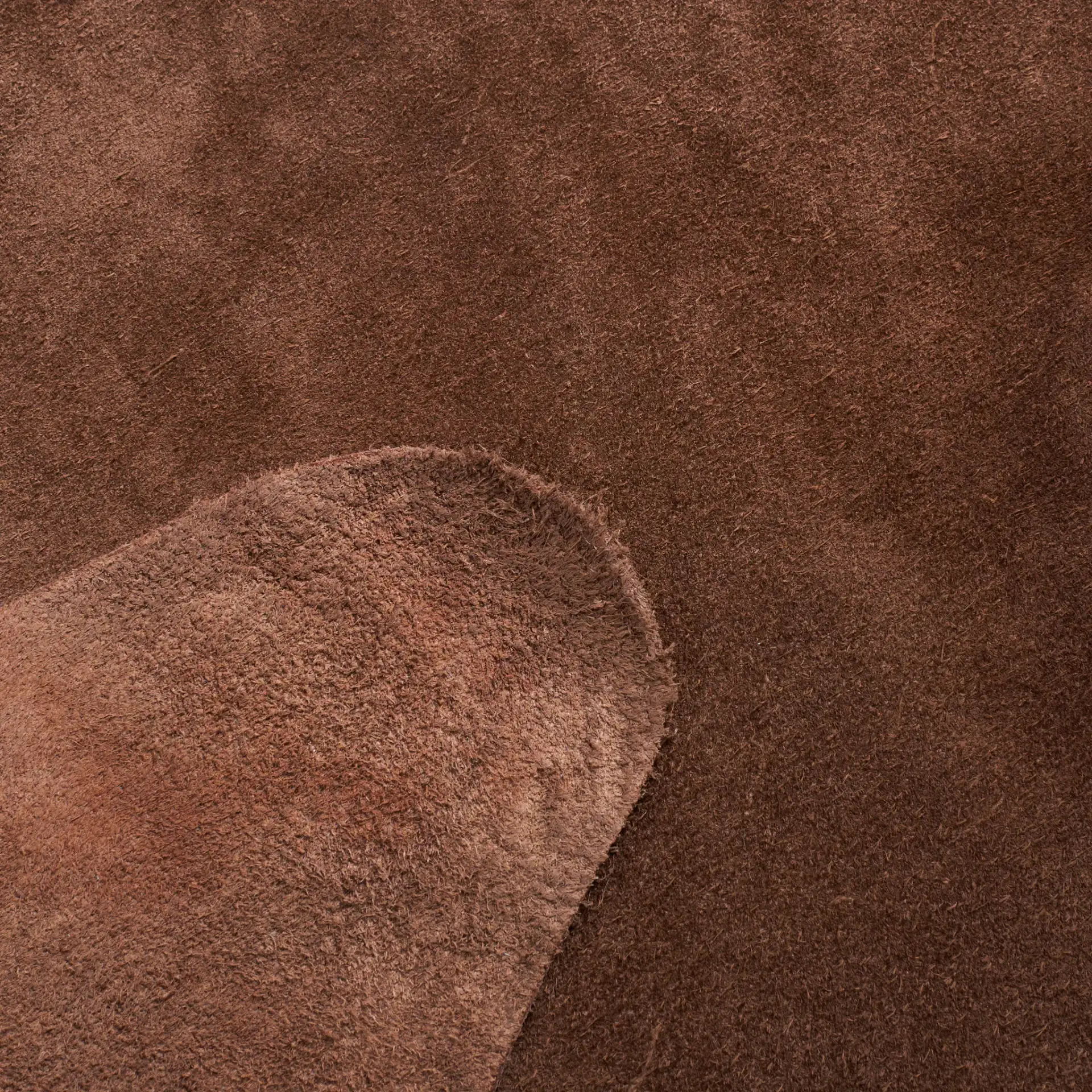 Suede Cowhide Shaped Rug in Light Brown in a styled room