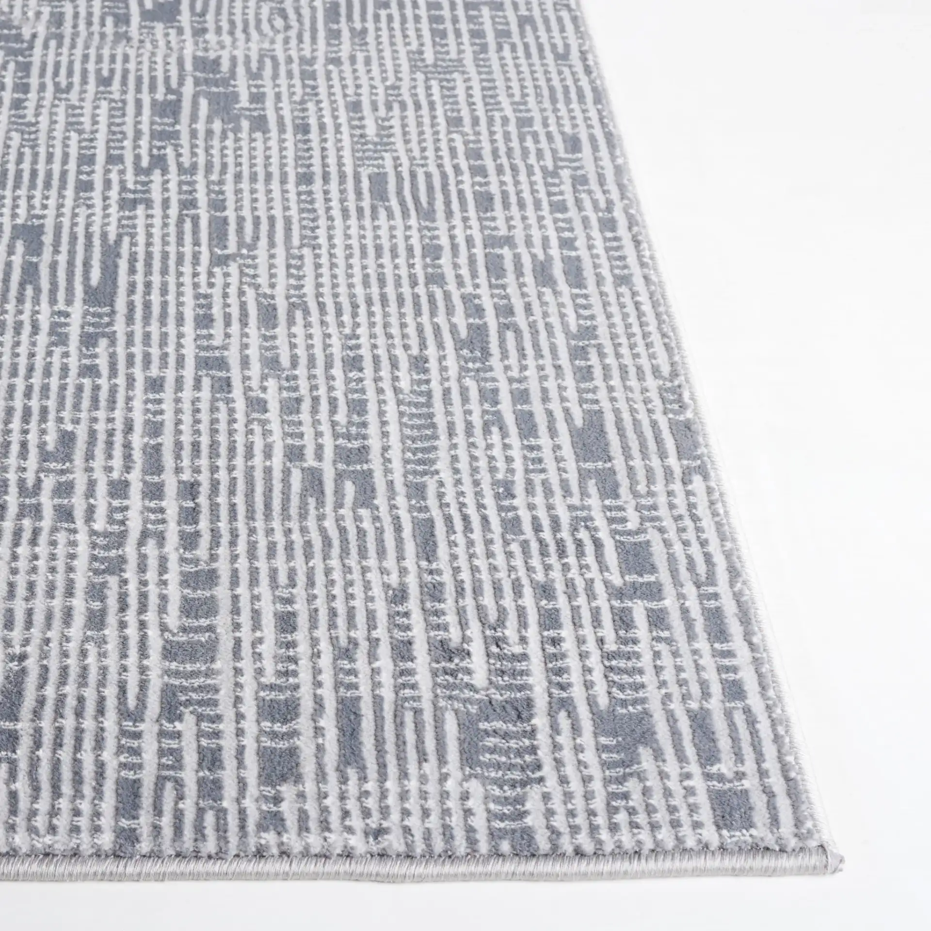 Continental Textured Linear Rug in Dark Gray / Light Gray in a styled room