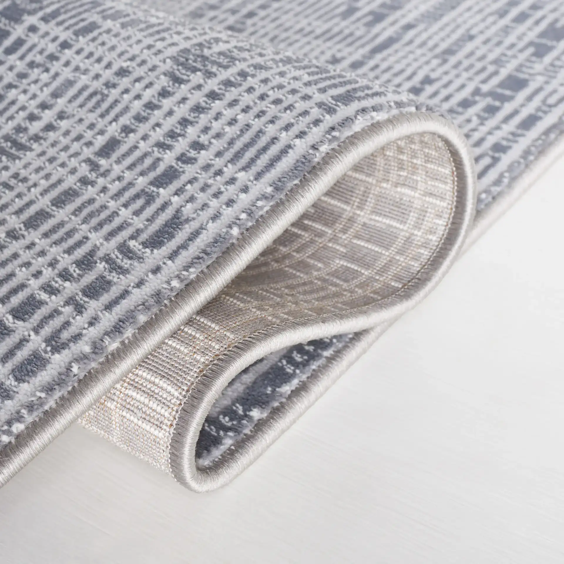 Continental Textured Linear Rug in Dark Gray / Light Gray in a styled room