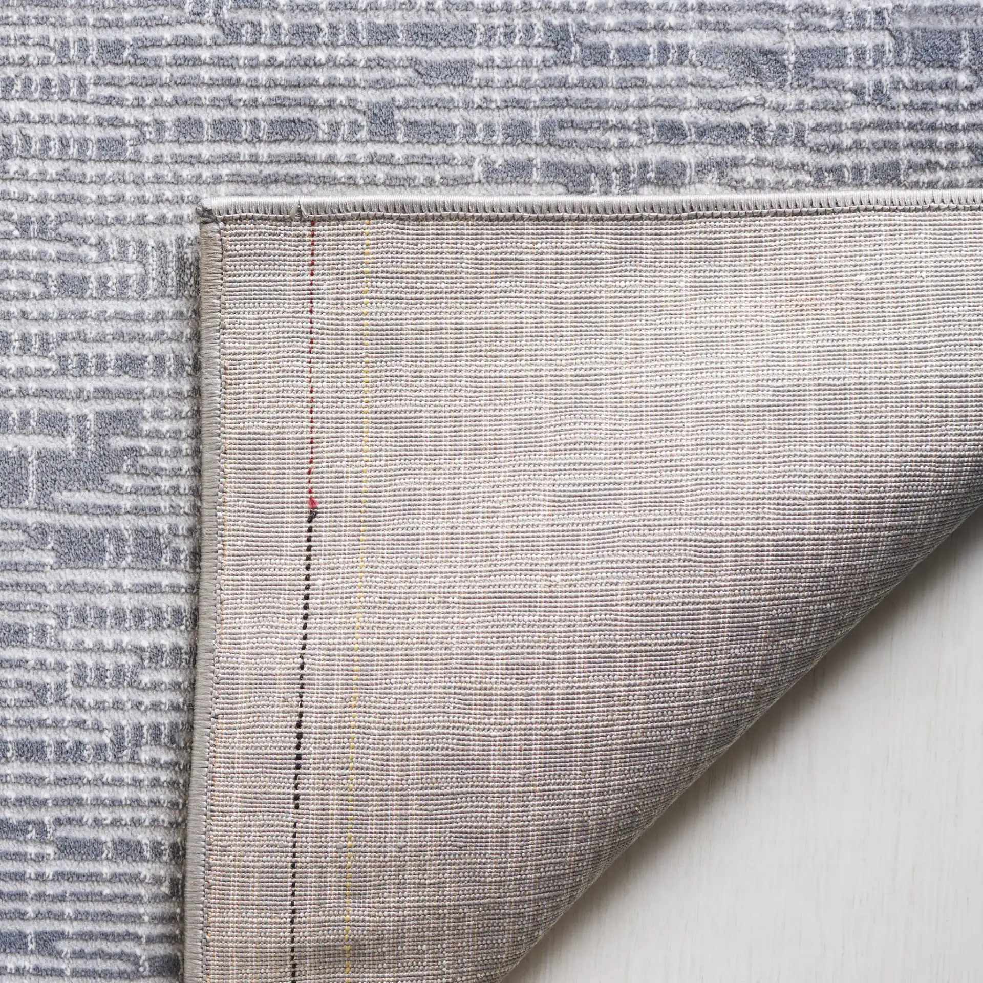 Continental Textured Linear Rug in Dark Gray / Light Gray in a styled room