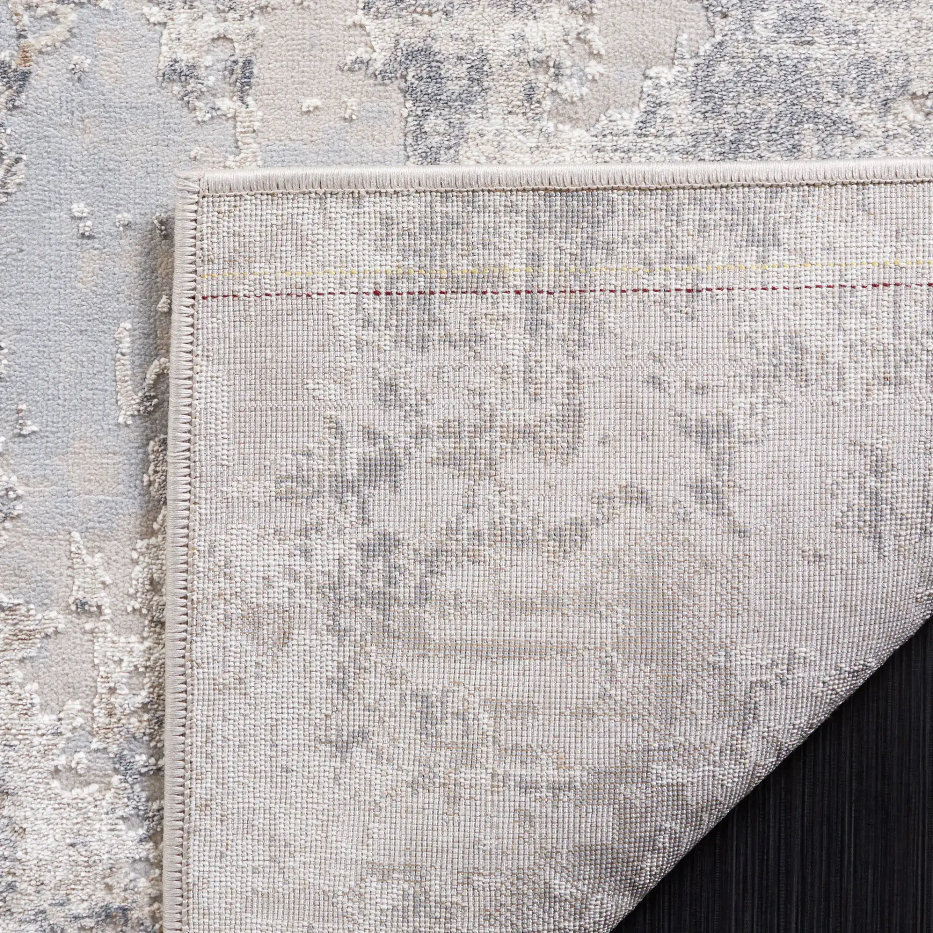 Continental Abstract Rug in Light Beige / Dark Gray in a styled room