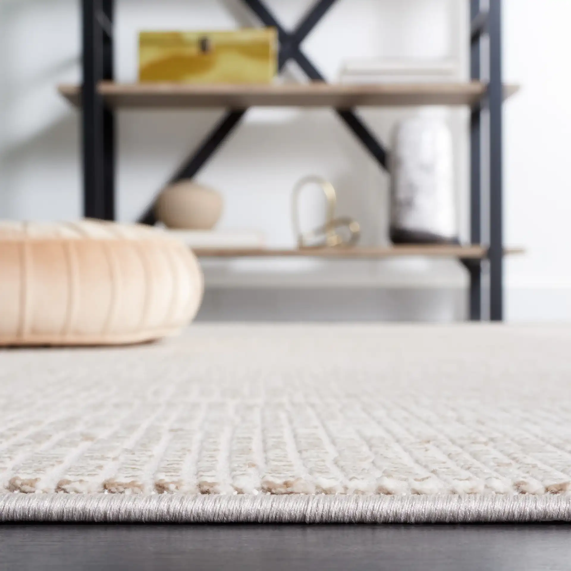 Continental Textured Border Rug in Ivory / Beige in a styled room