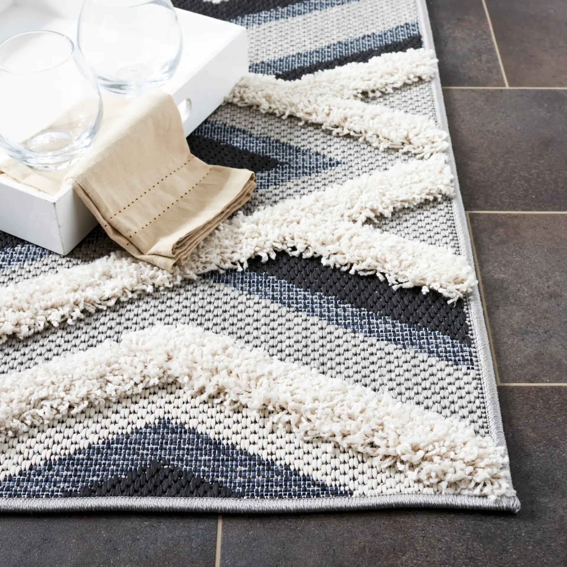 Cottage Nested Diamond Outdoor Rug in Ivory / Black in a styled room