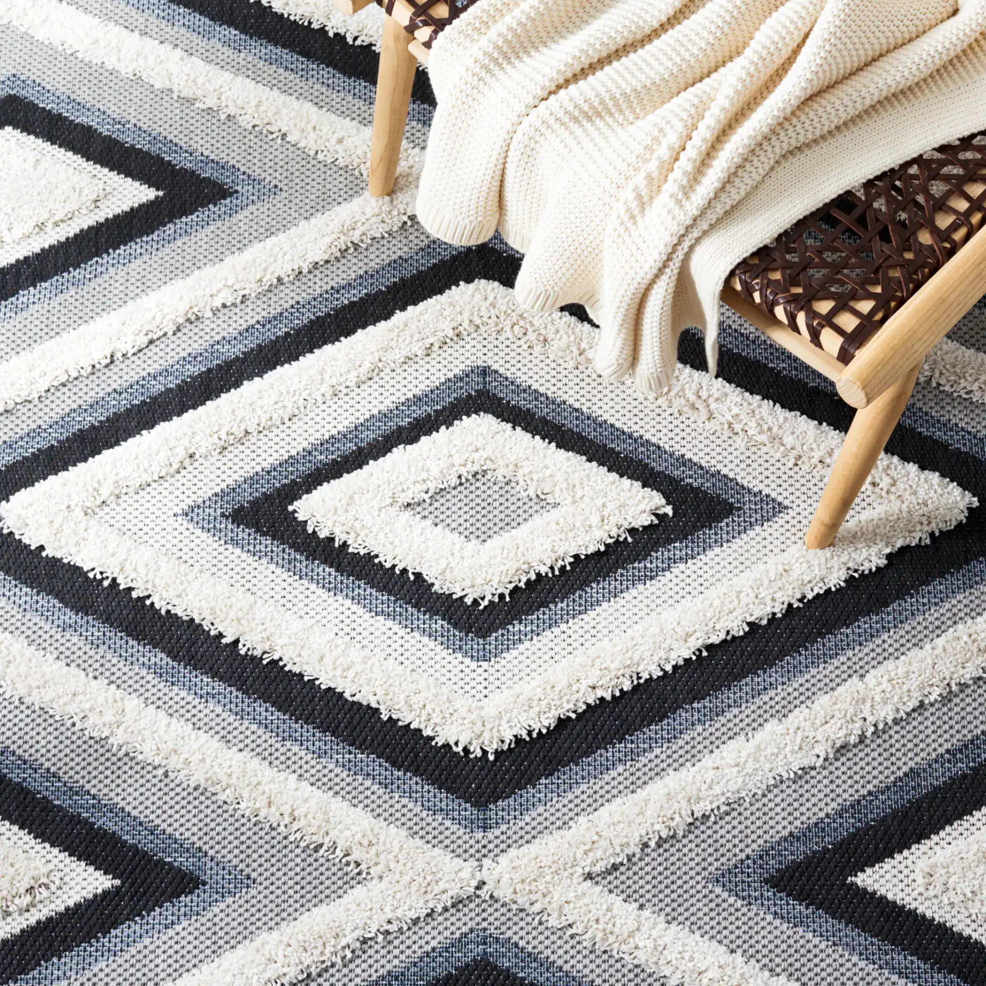 Cottage Nested Diamond Outdoor Rug in Ivory / Black in a styled room