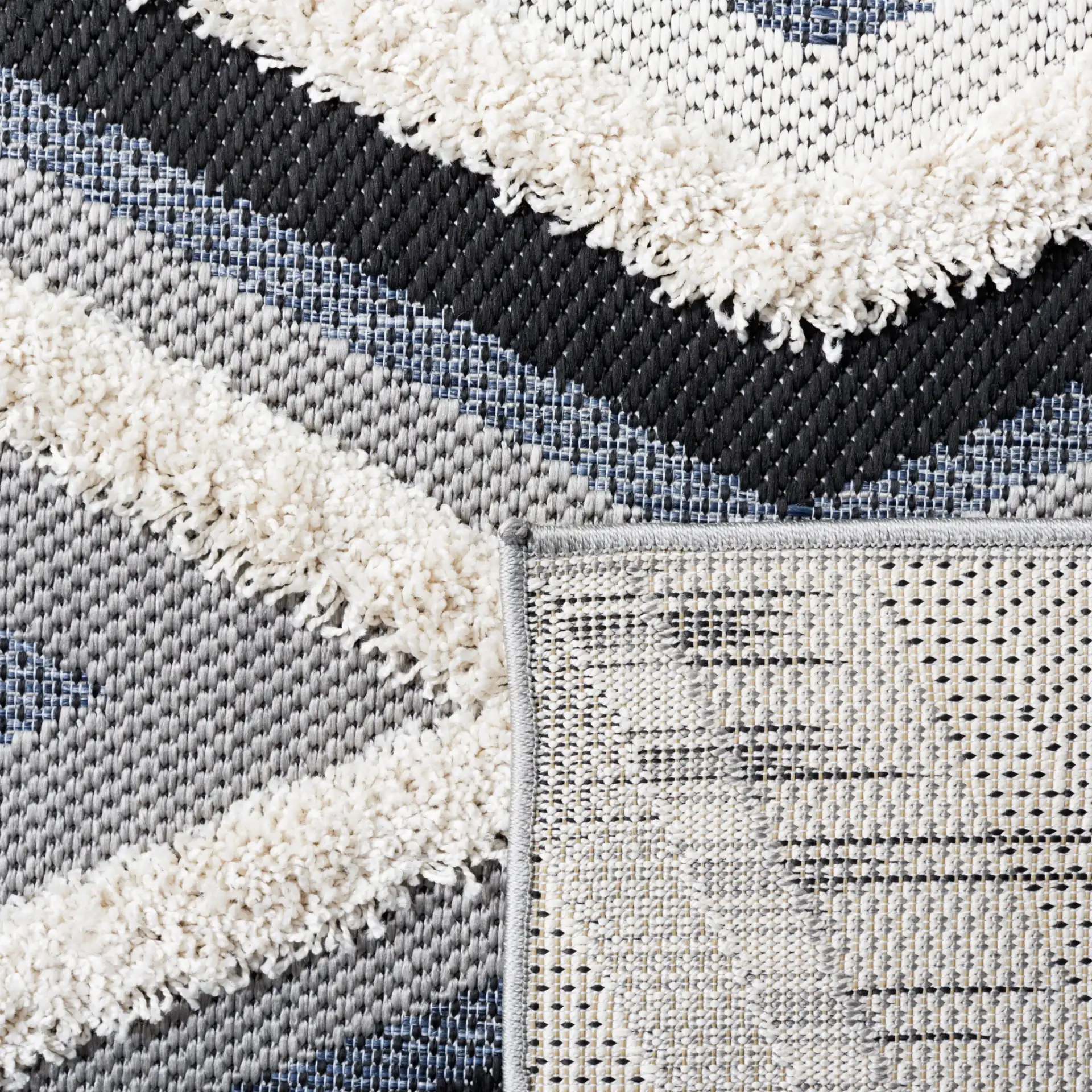 Cottage Nested Diamond Outdoor Rug in Ivory / Black in a styled room