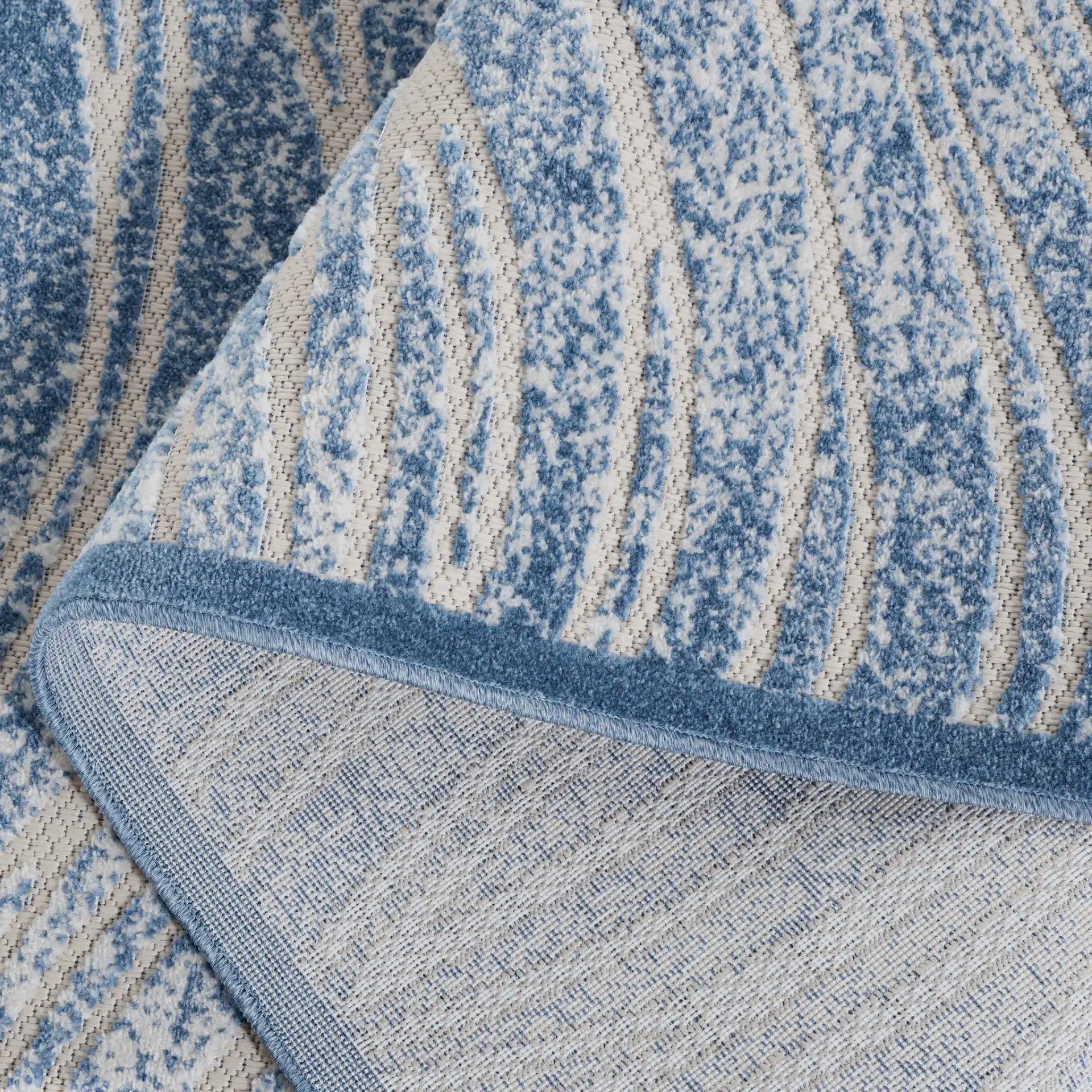 Cottage Ripple Outdoor Rug in Blue in a styled room