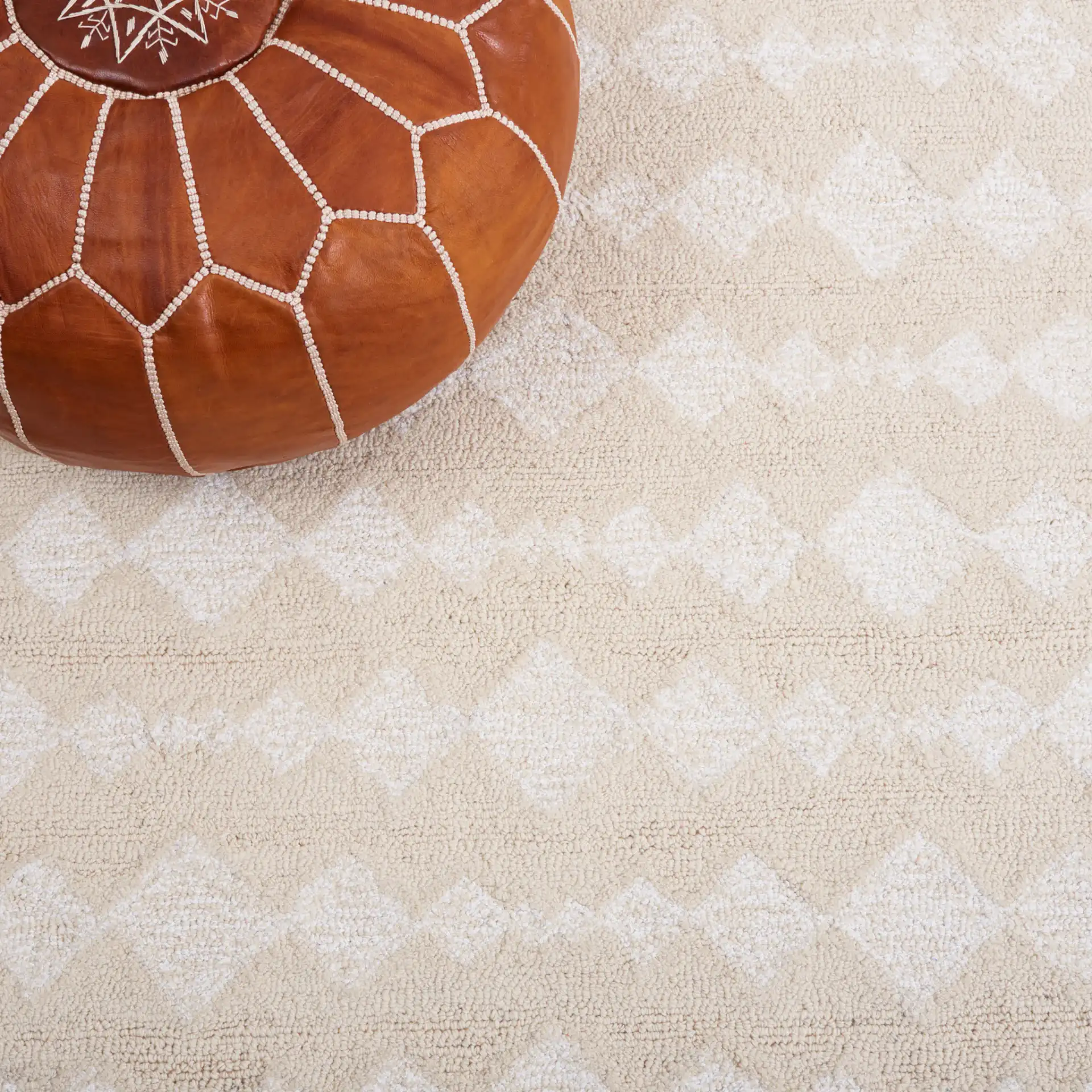 Capri Solid Bordered Hand-Tufted Rug in Ivory / Beige in a styled room