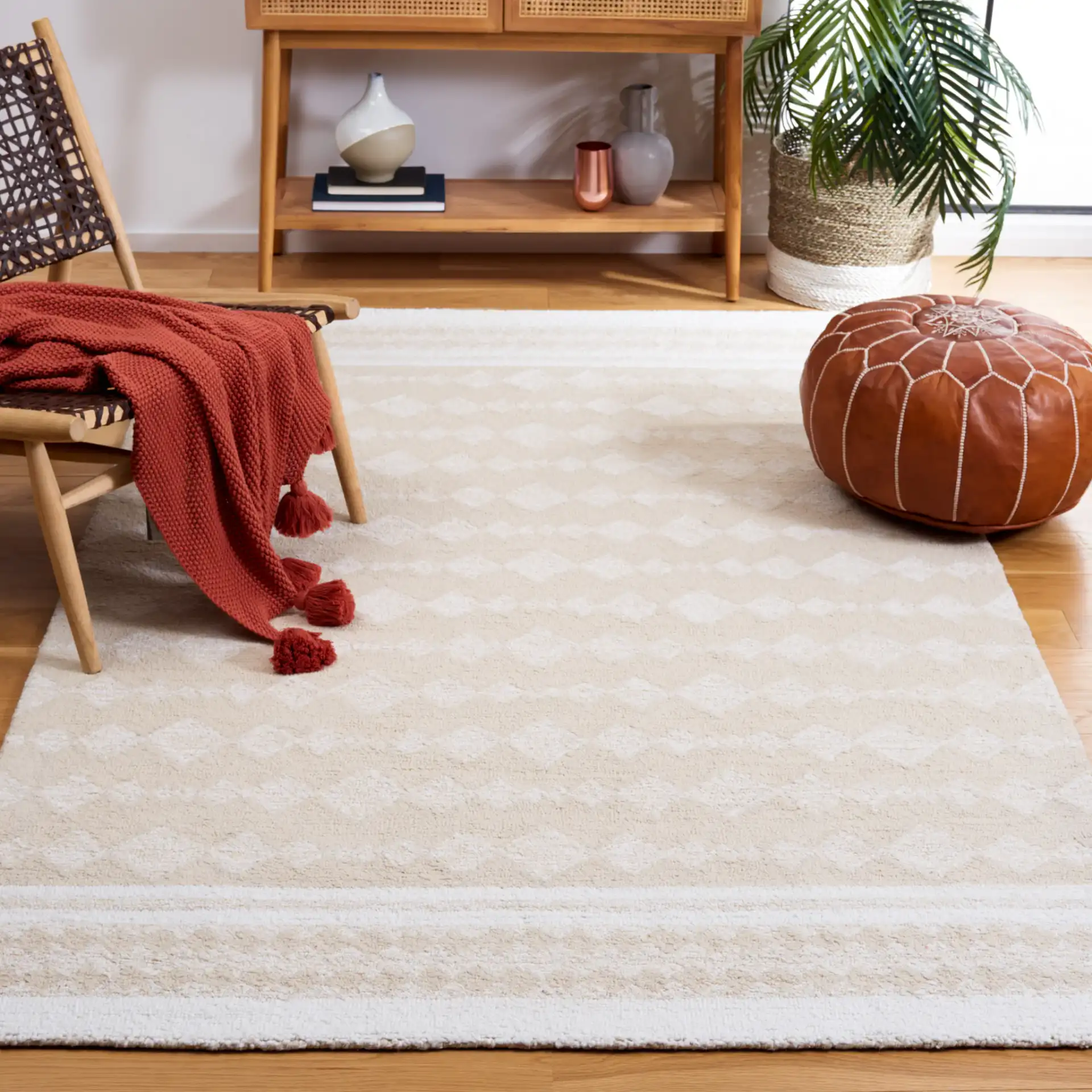 Capri Solid Bordered Hand-Tufted Rug in Ivory / Beige in a styled room