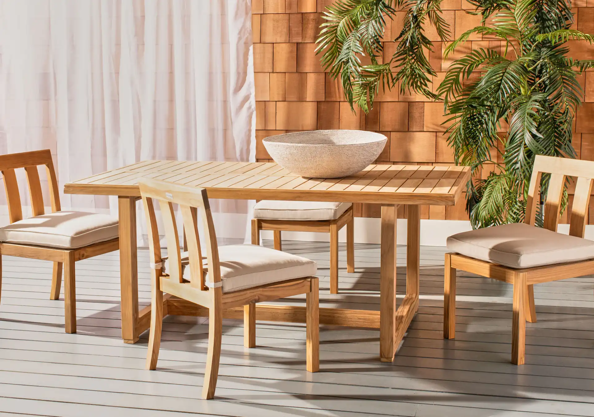 Montford Teak Dining Table in Natural Teak in a styled room