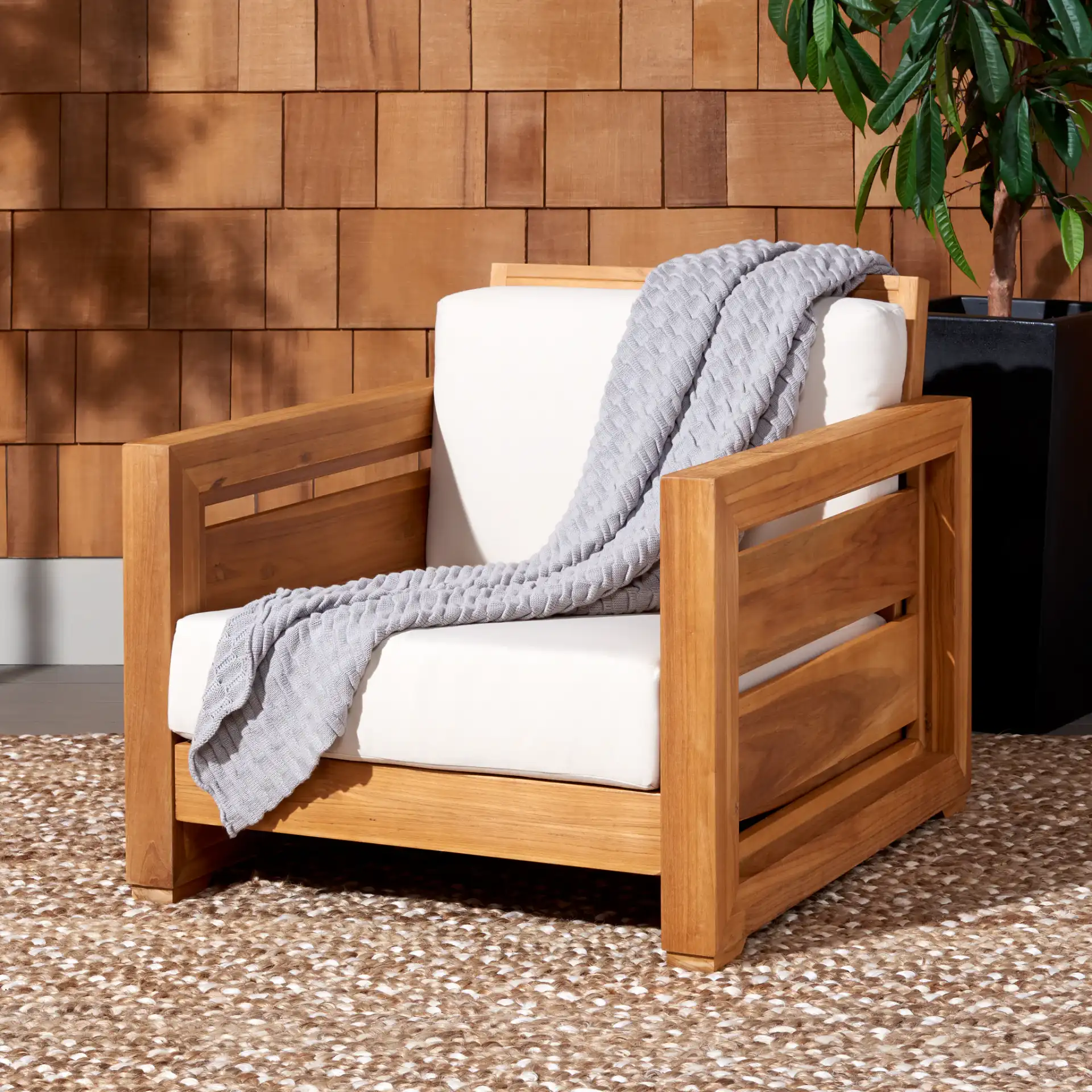 Molokai Teak Patio Chair in Natural / White in a styled room