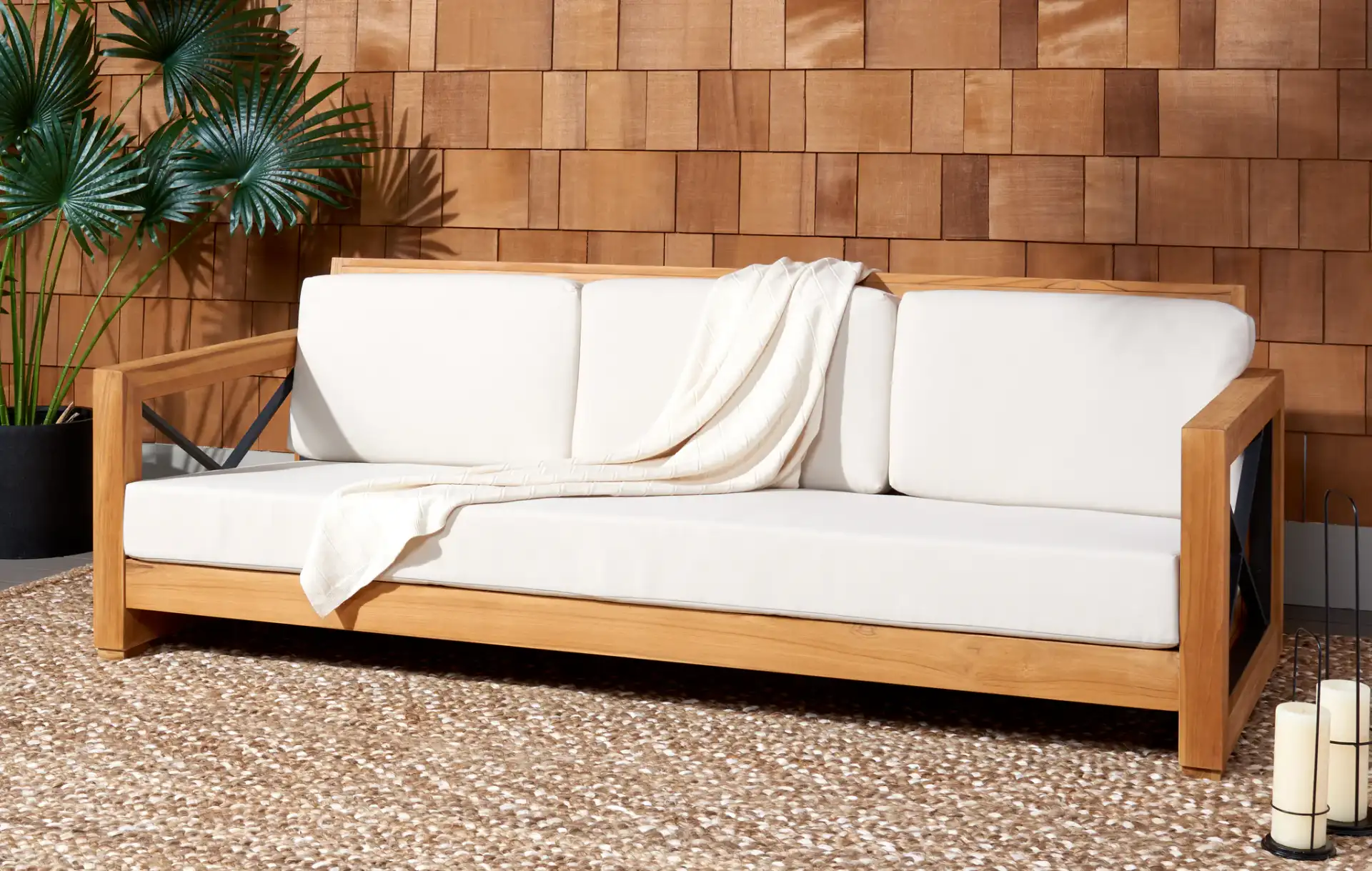 Andros Teak Patio Sofa in Natural / Beige in a styled room