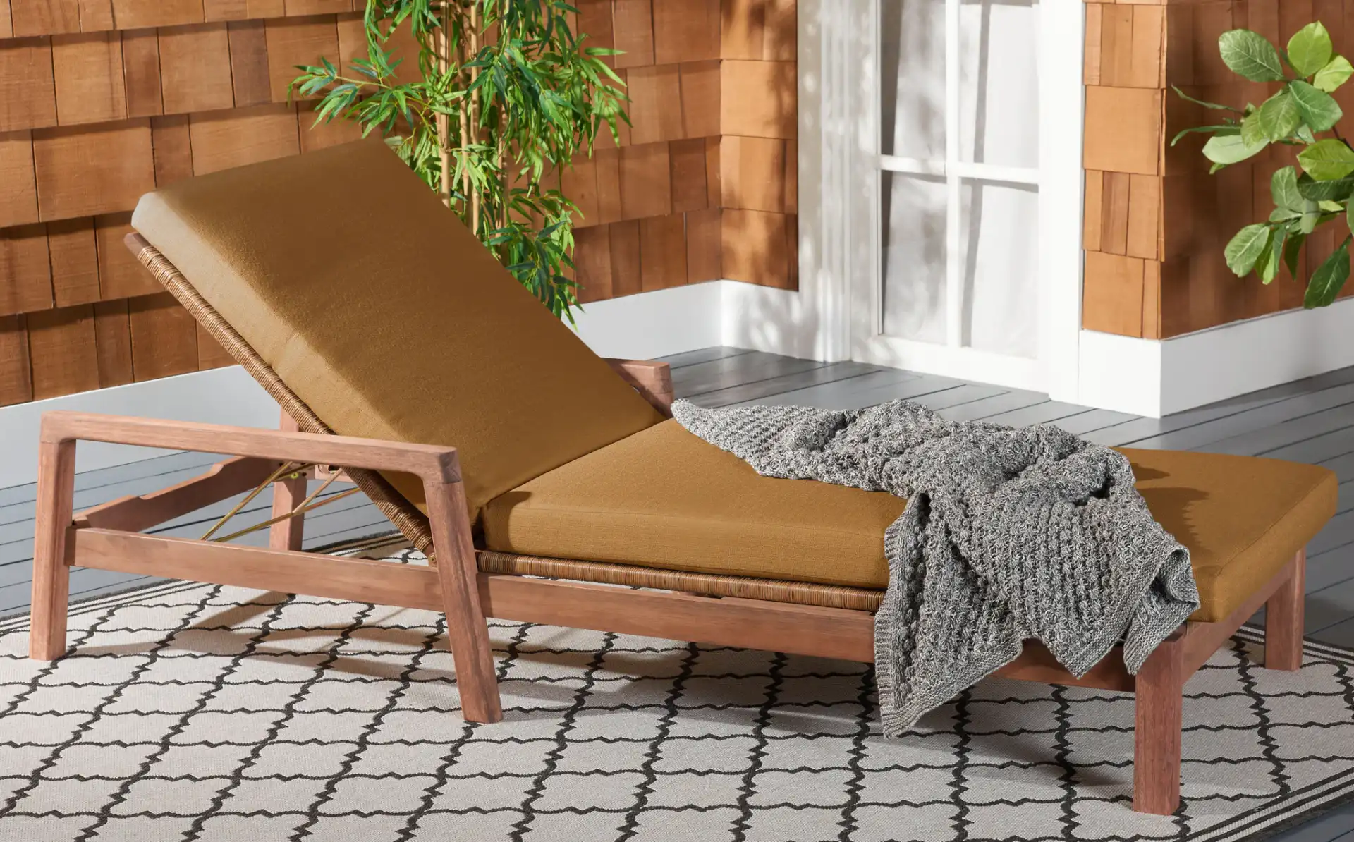 Donnamaria Wicker Sun Lounger in Natural / Brown in a styled room