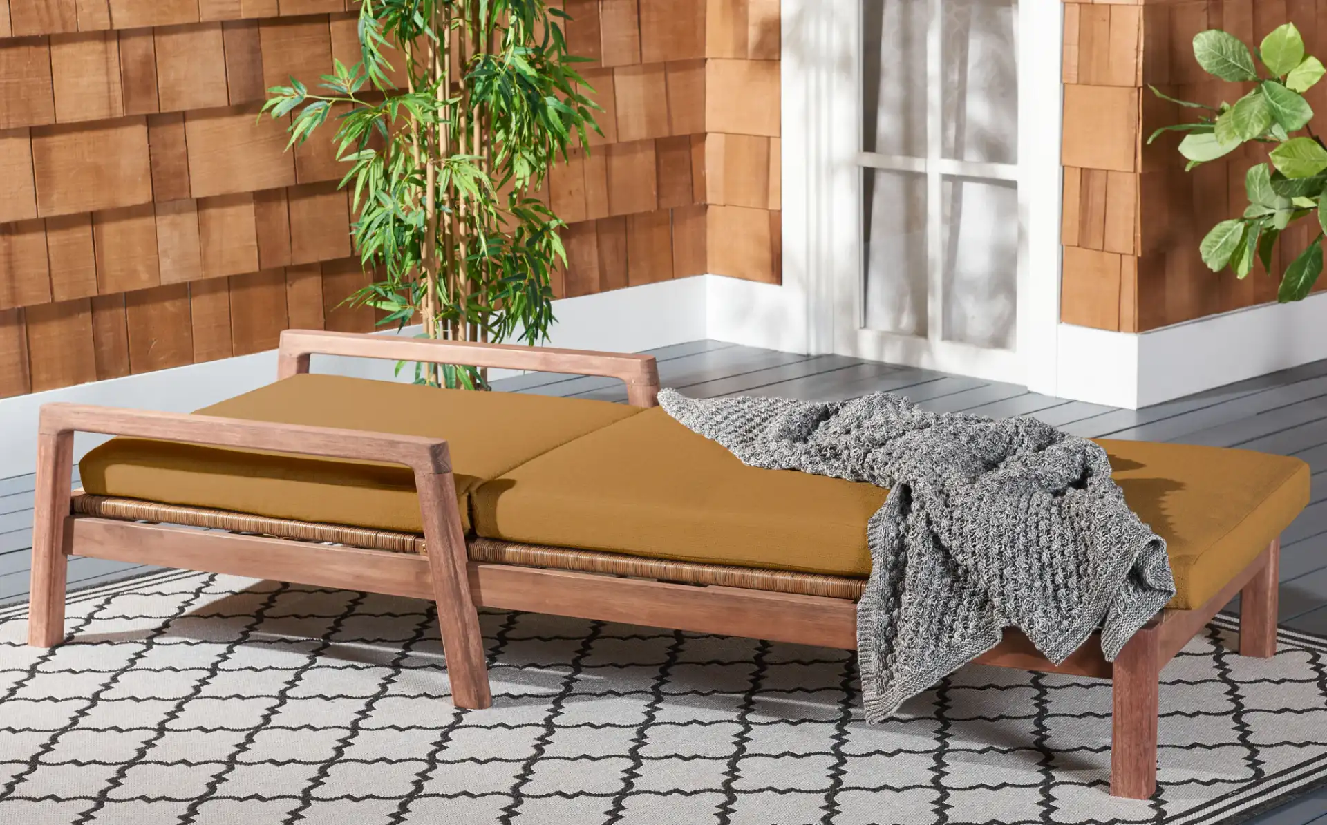 Donnamaria Wicker Sun Lounger in Natural / Brown in a styled room