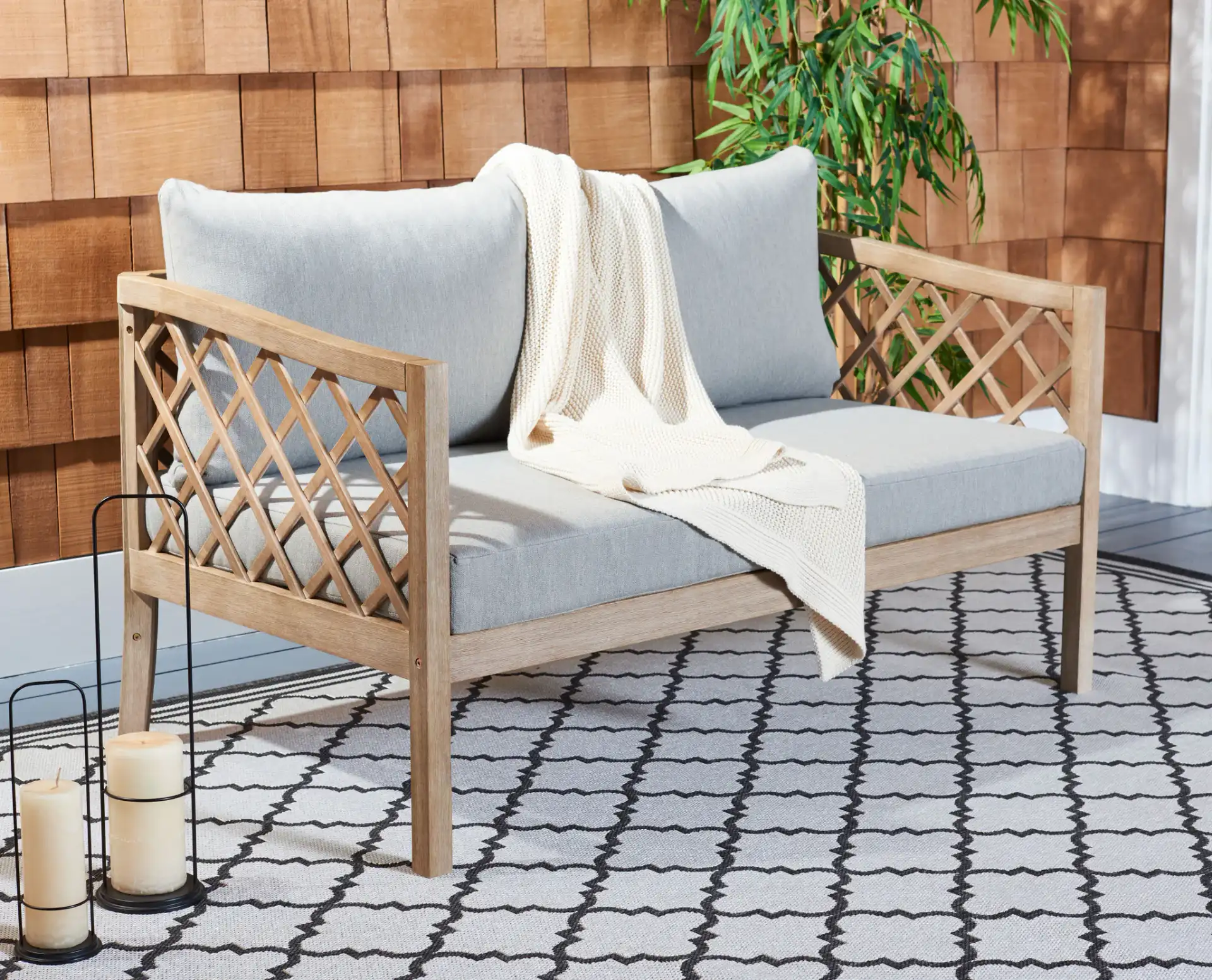 Fiji Wood Patio Sofa in Brown / Light Gray in a styled room