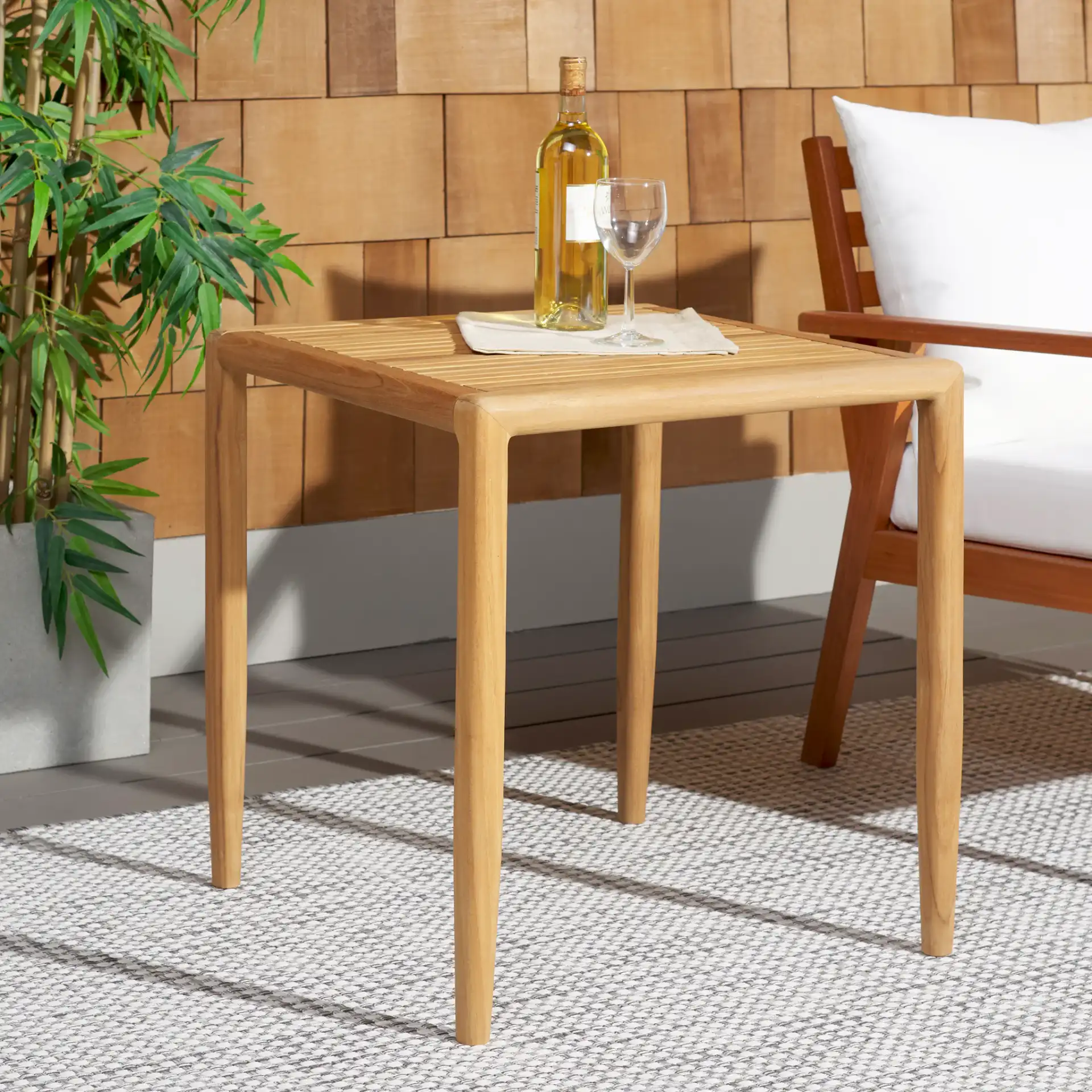 Tortuga Patio Chair in Natural / White in a styled room