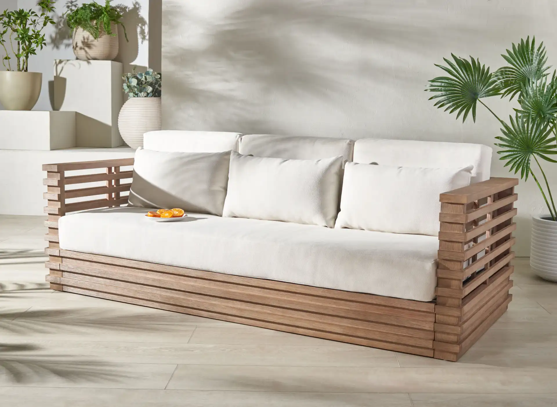 Tortuga Patio Sofa in Natural / White in a styled room