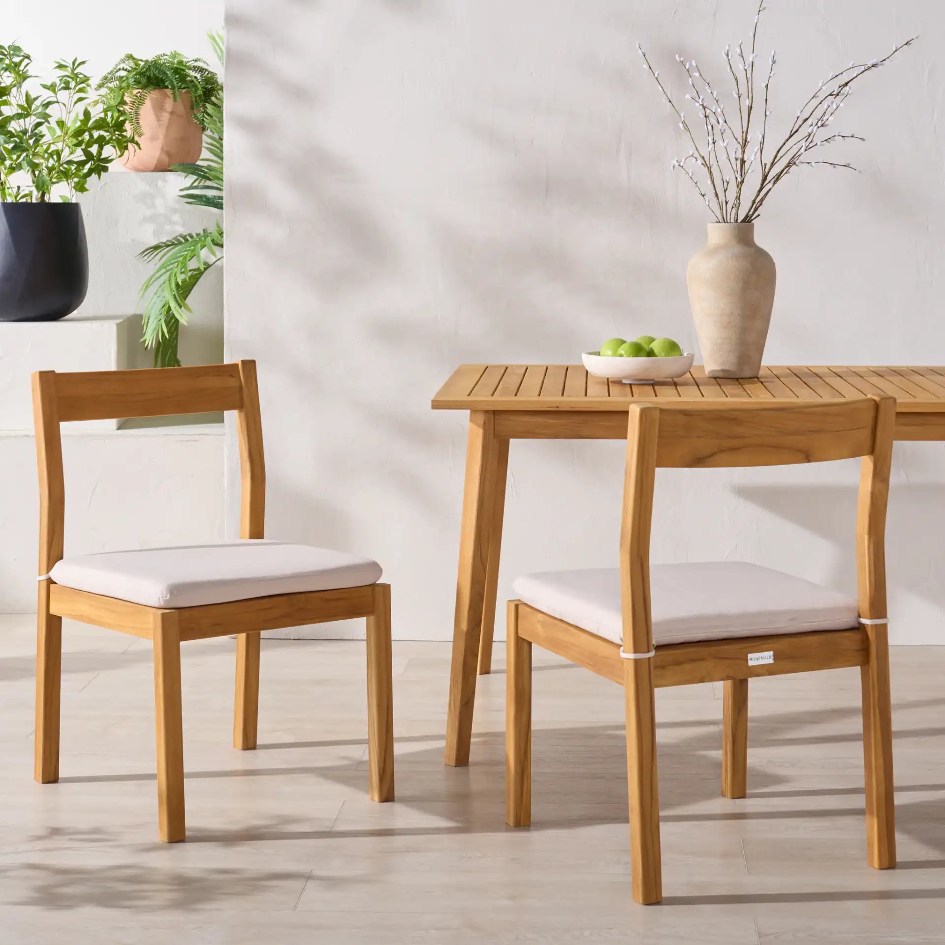 Mayaguana Teak Dining Chair (Set of 2) in Natural / White in a styled room