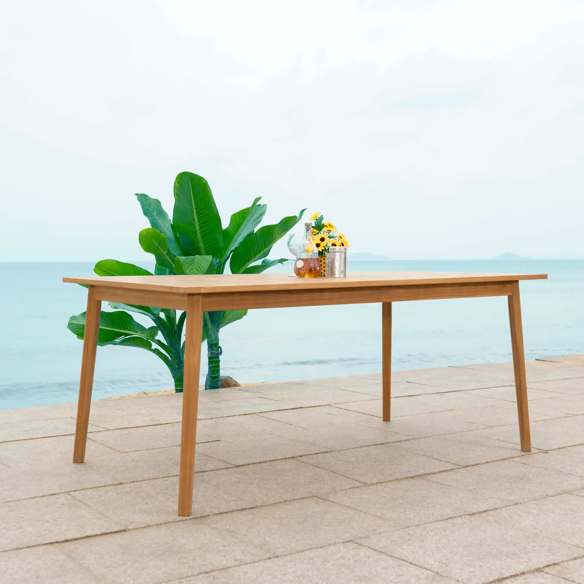 Mayaguana Teak Dining Table in Natural in a styled room