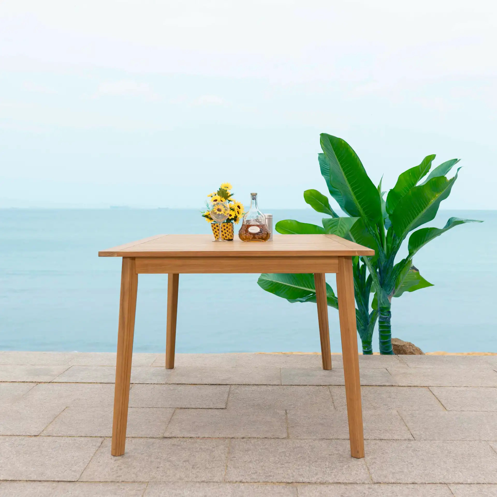 Mayaguana Teak Dining Table in Natural in a styled room
