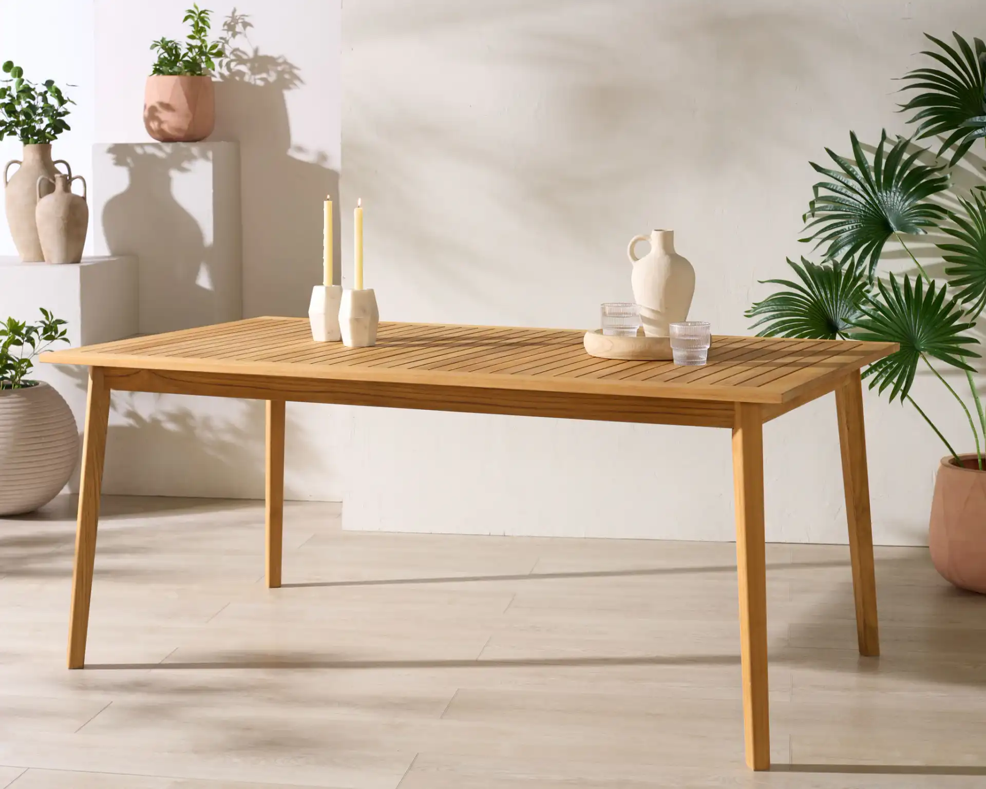 Mayaguana Teak Dining Table in Natural in a styled room