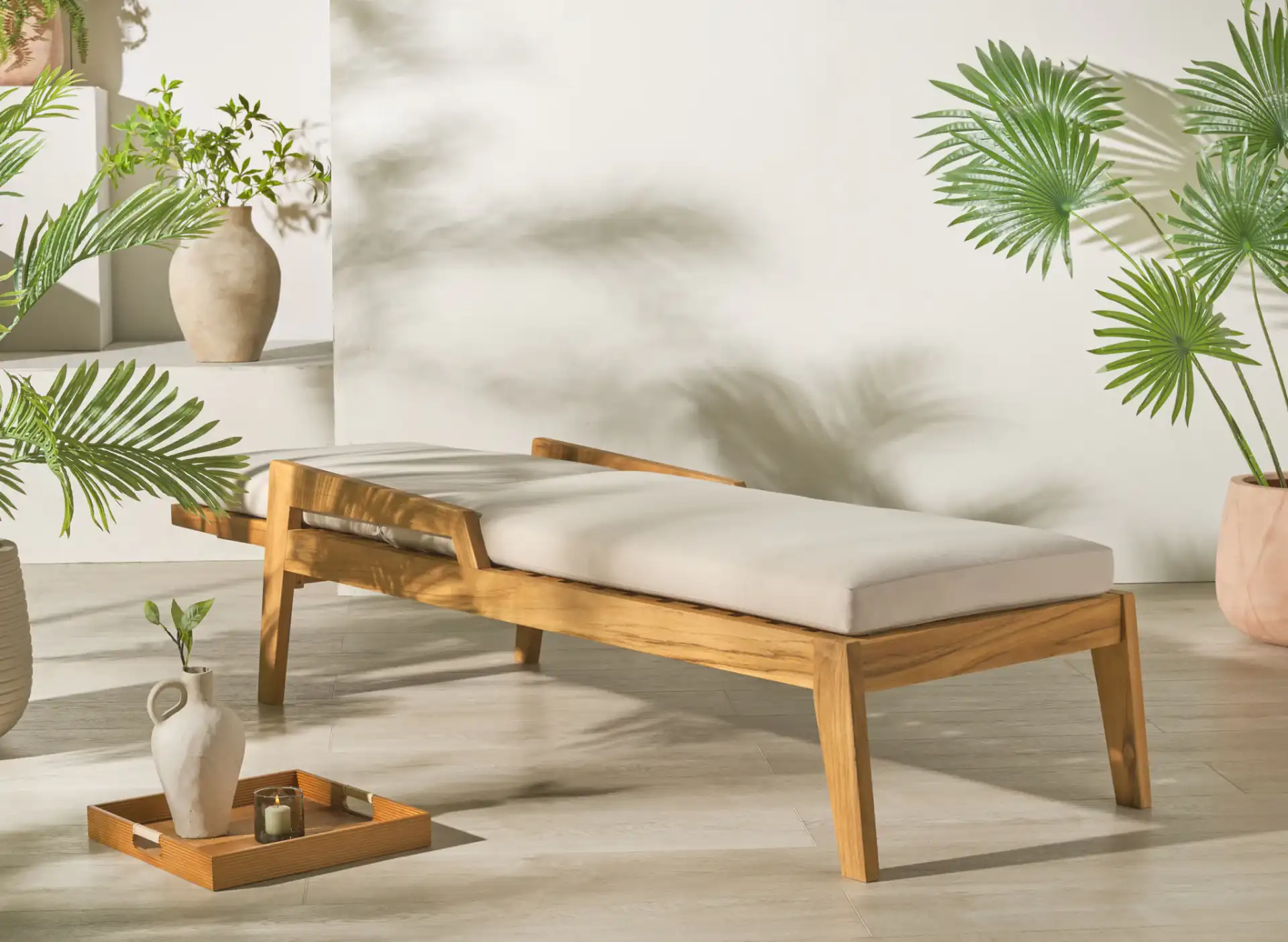 Caledonia Teak Chaise Lounge in Natural / White in a styled room