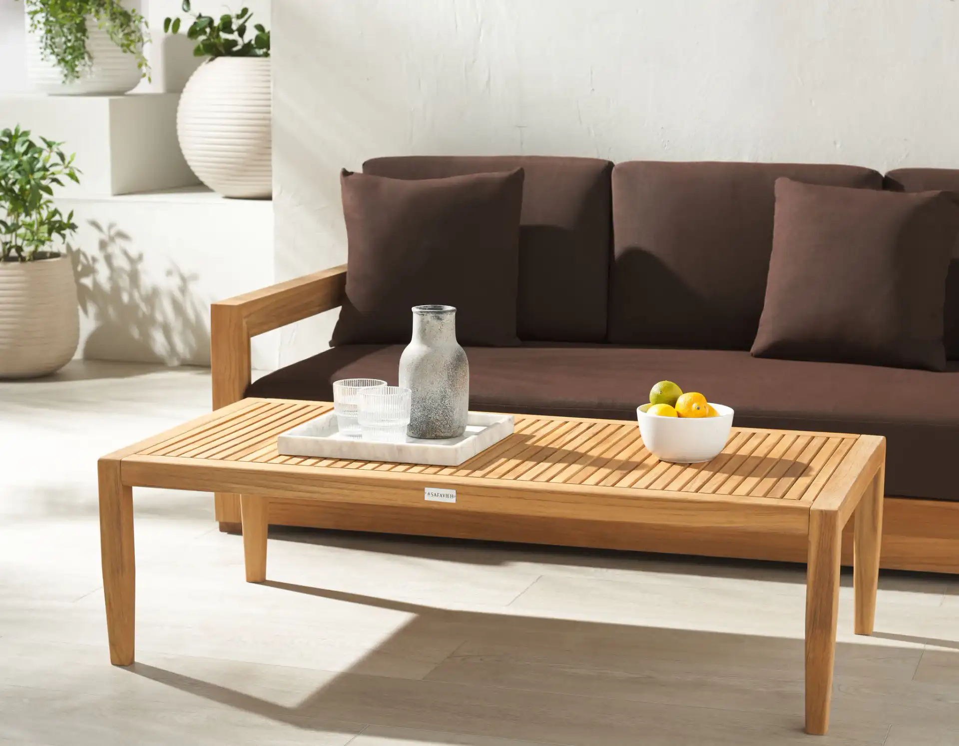 Samoa Teak Patio Coffee Table in Natural in a styled room