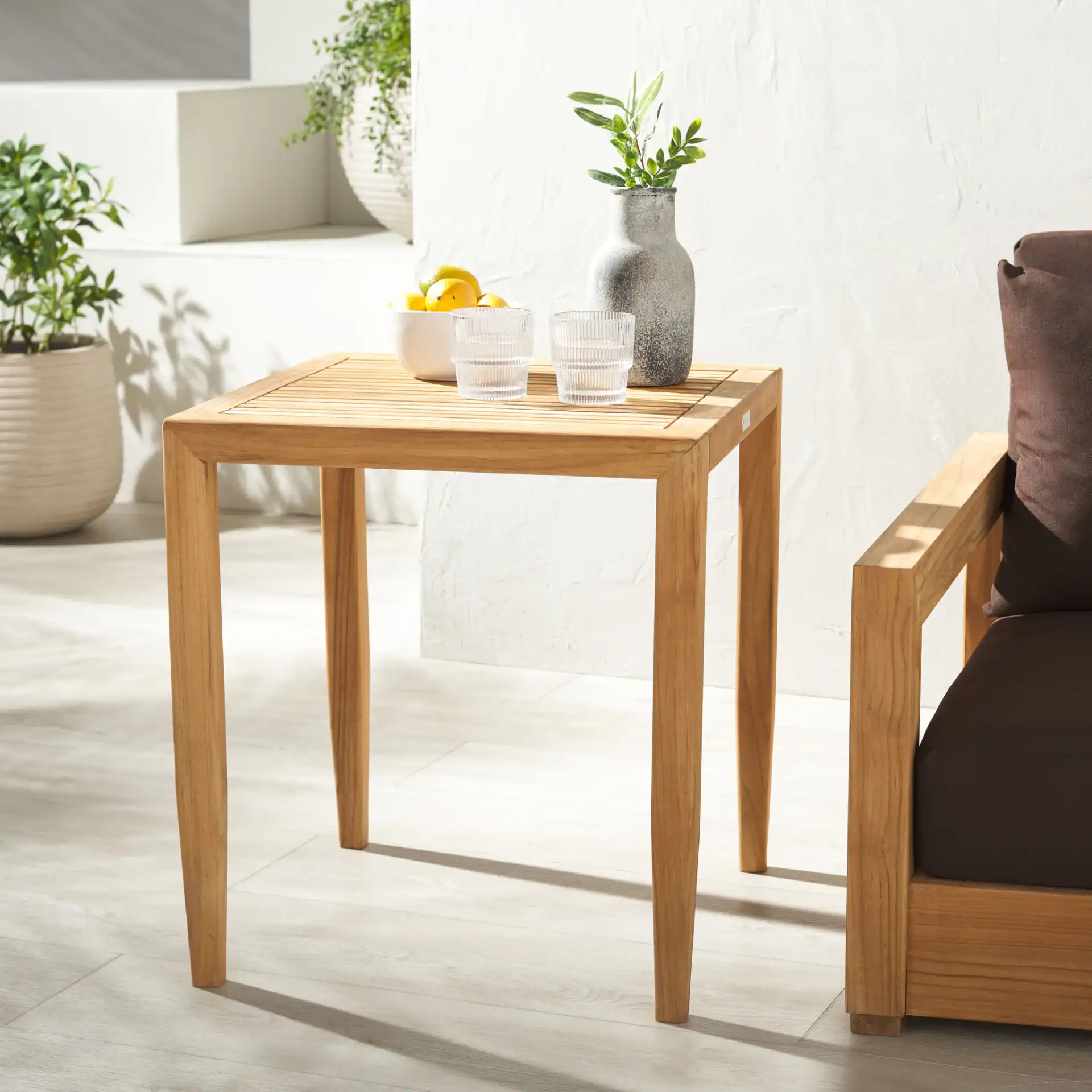 Samoa Teak Patio Accent Table in Natural in a styled room