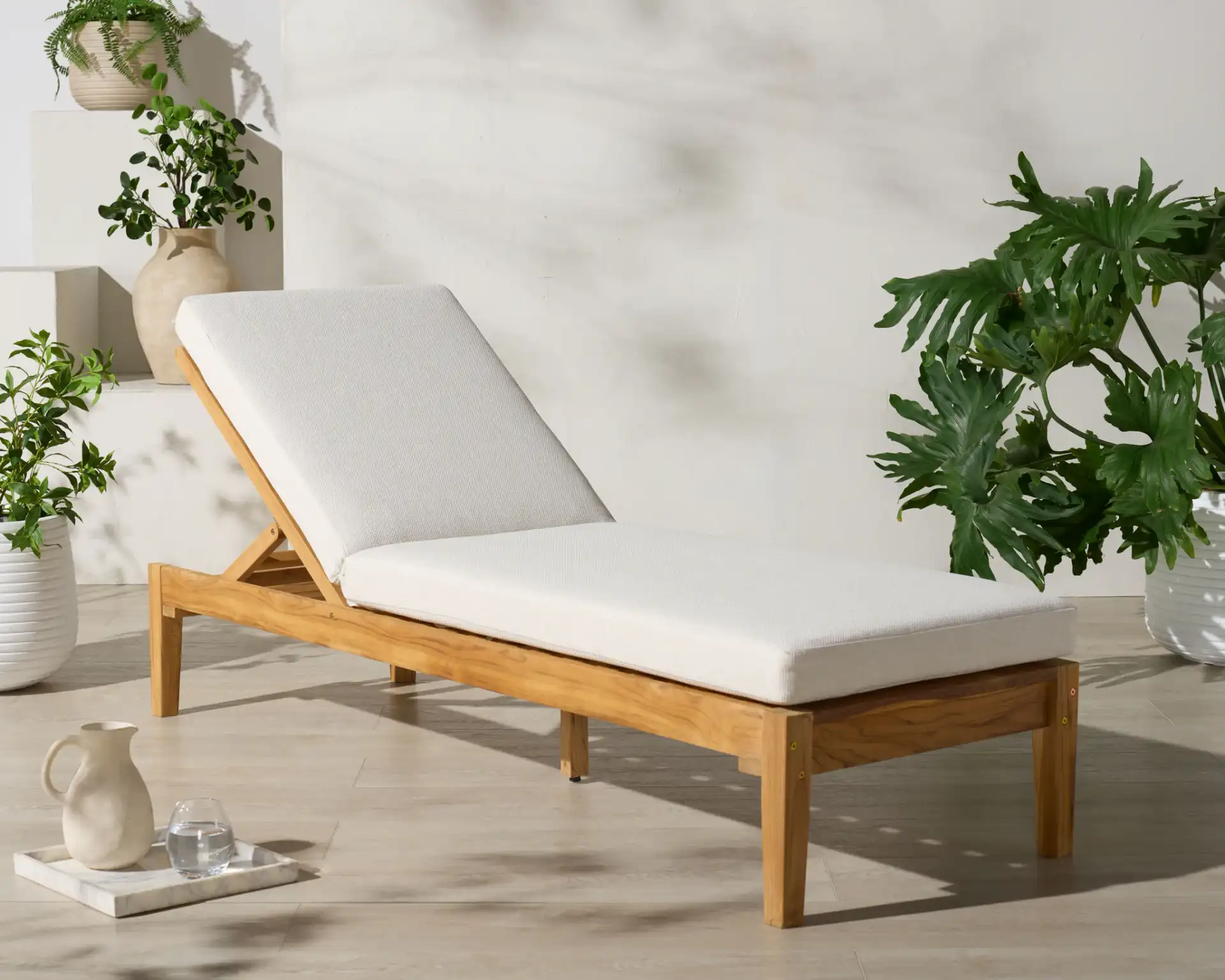 Montclair Teak Chaise Lounge in White / Natural Teak in a styled room