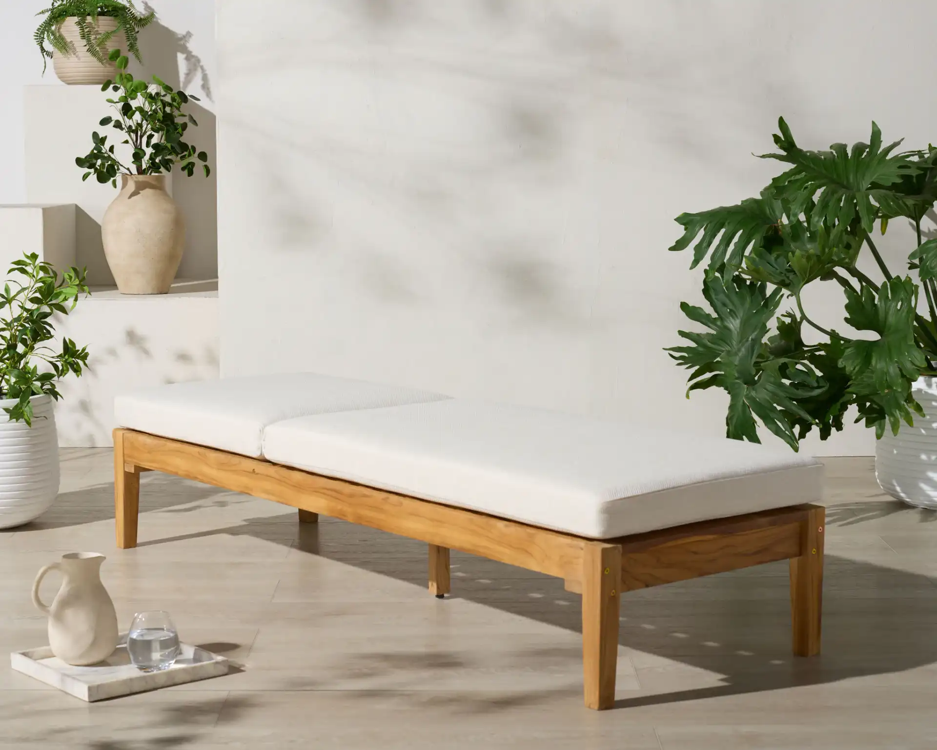 Montclair Teak Chaise Lounge in White / Natural Teak in a styled room