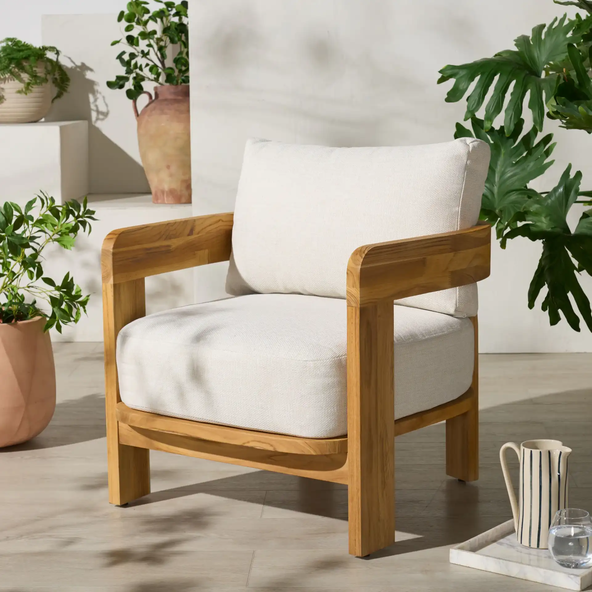 Achilles Teak Patio Chair in White / Natural Teak in a styled room