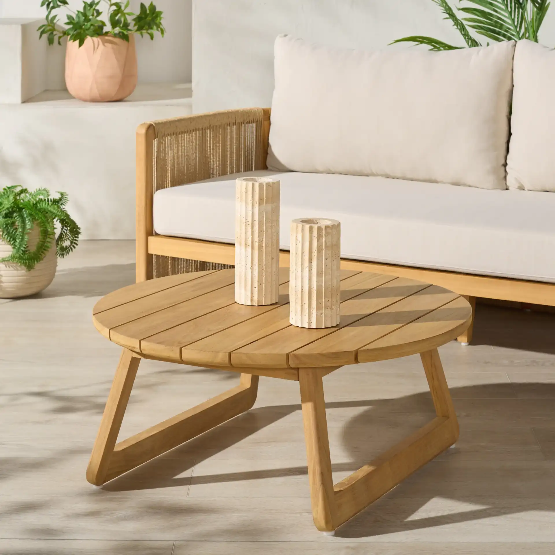Gale Teak Outdoor Coffee Table in Natural in a styled room