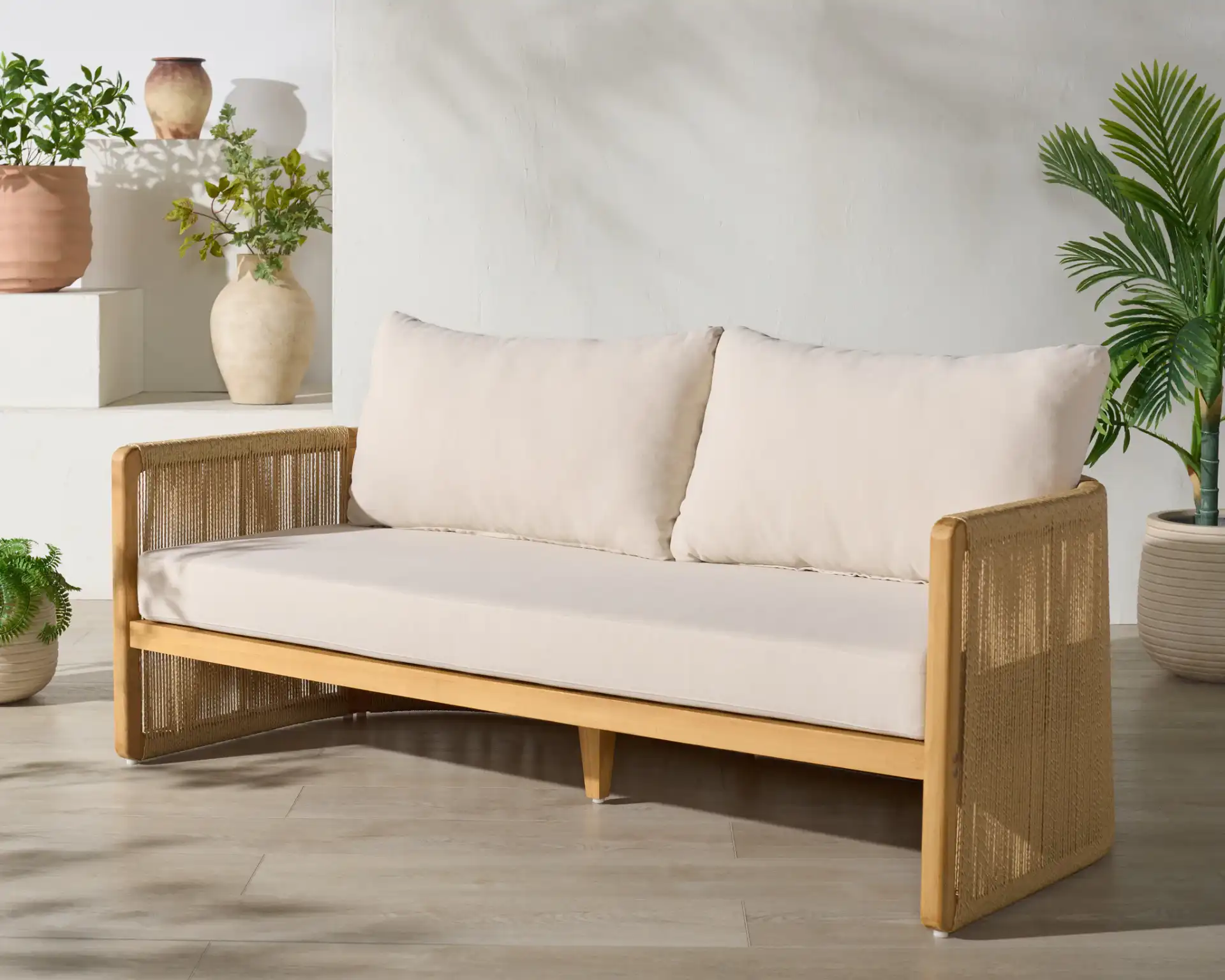 Gale Teak And Hyacinth Patio Sofa in Natural / Beige in a styled room