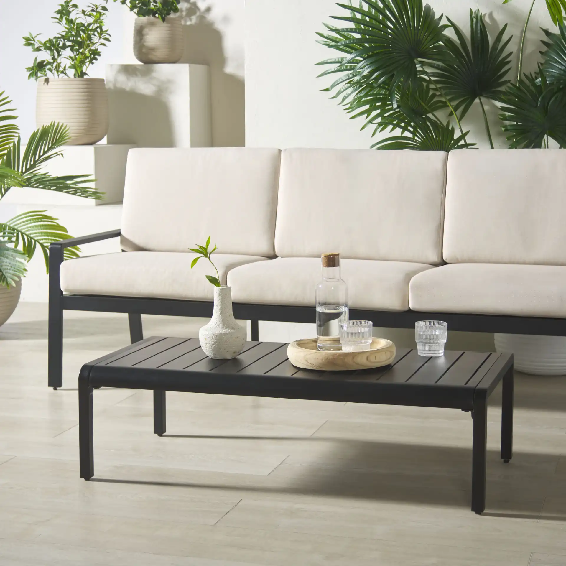 Guam Outdoor Coffee Table in Black in a styled room