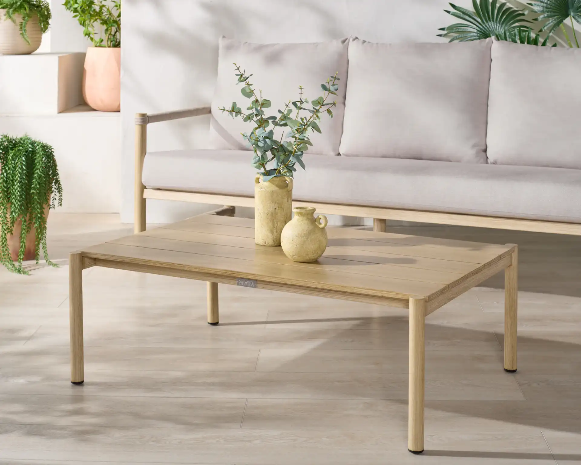 Dorianna Aluminum Coffee Table in Sand in a styled room