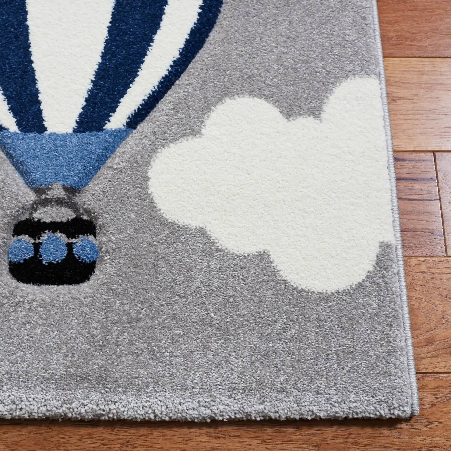 Carousel Kids Aviation Sky Rug in Light Gray / Red in a styled room