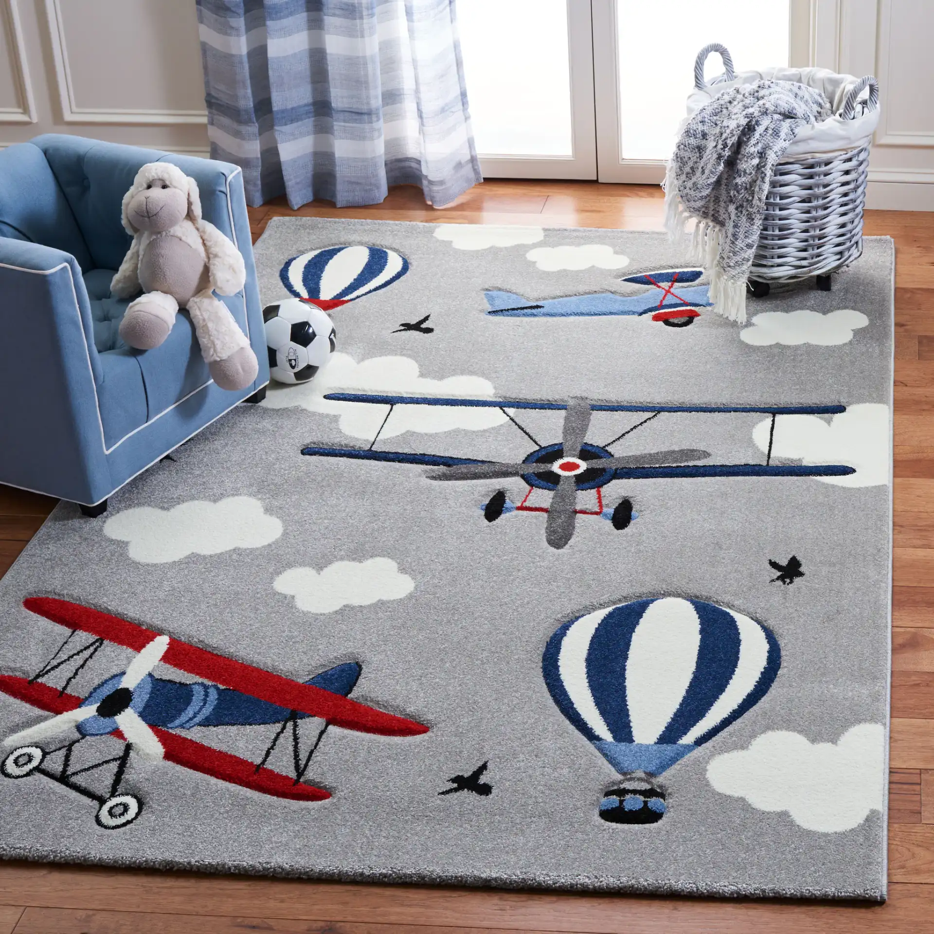 Carousel Kids Aviation Sky Rug in Light Gray / Red in a styled room