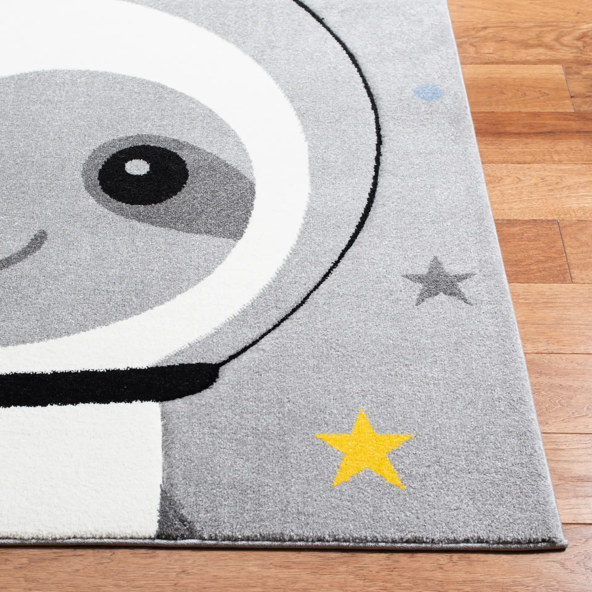 Carousel Kids Astronaut Sloth Rug in Gray / Ivory in a styled room
